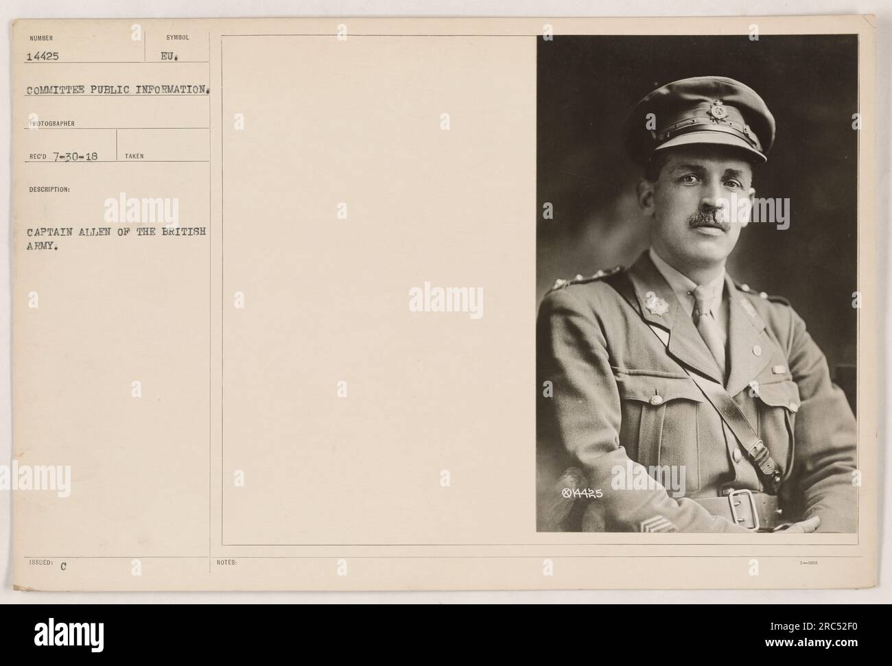 Captain Allen of the British Army holding a symbol issued to him. The photograph was taken as part of the Committee on Public Information during World War One. The photo has the identification number 14425 and is from the collection dated 7-30-18. Stock Photo