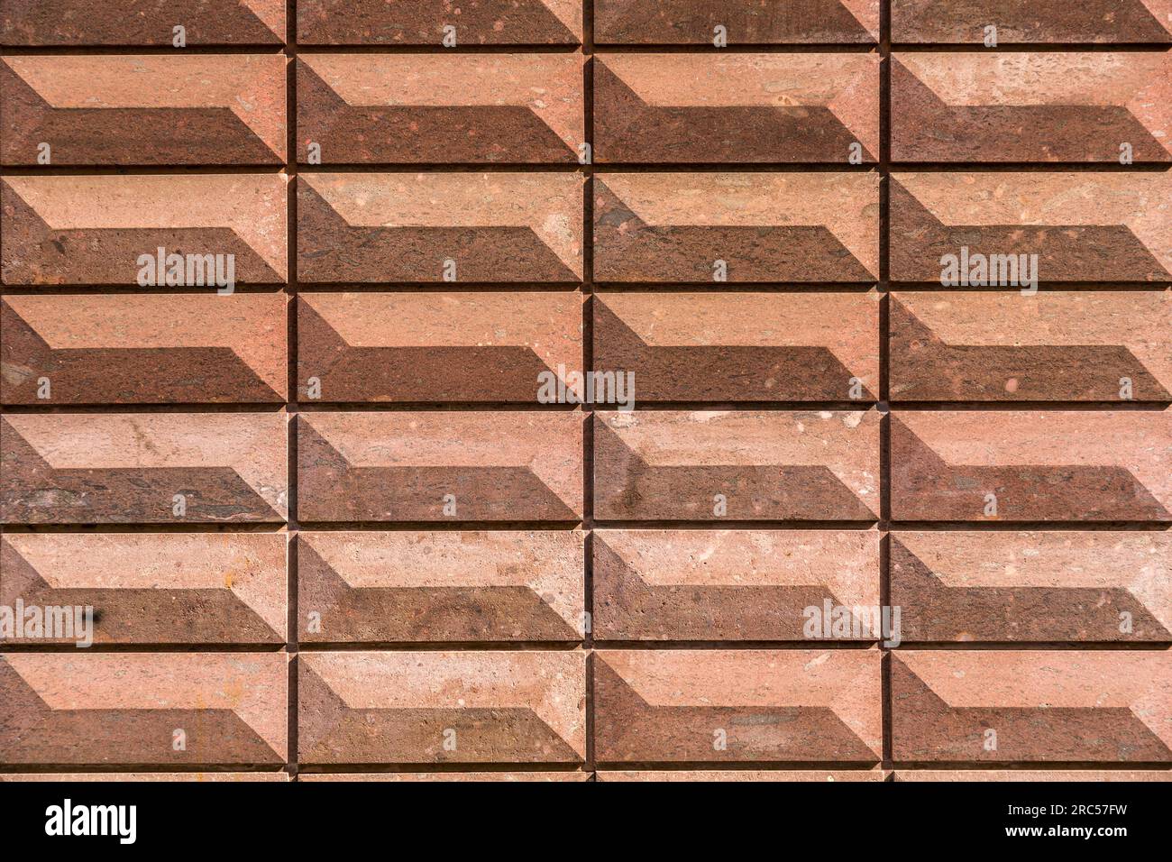Rectangular bas relief stone tiled blocks close up texture background, textured and stained surface design element Stock Photo