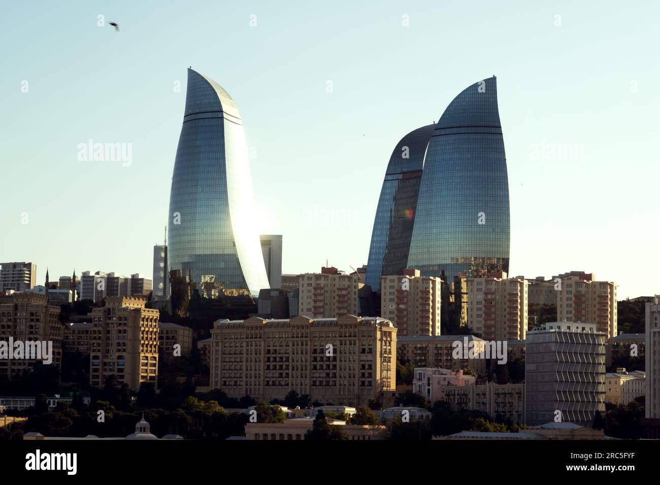 Baku, Azerbaijan - June 25, 2023: An evening shot of the iconic Flame Towers basking in the golden sunlight Stock Photo