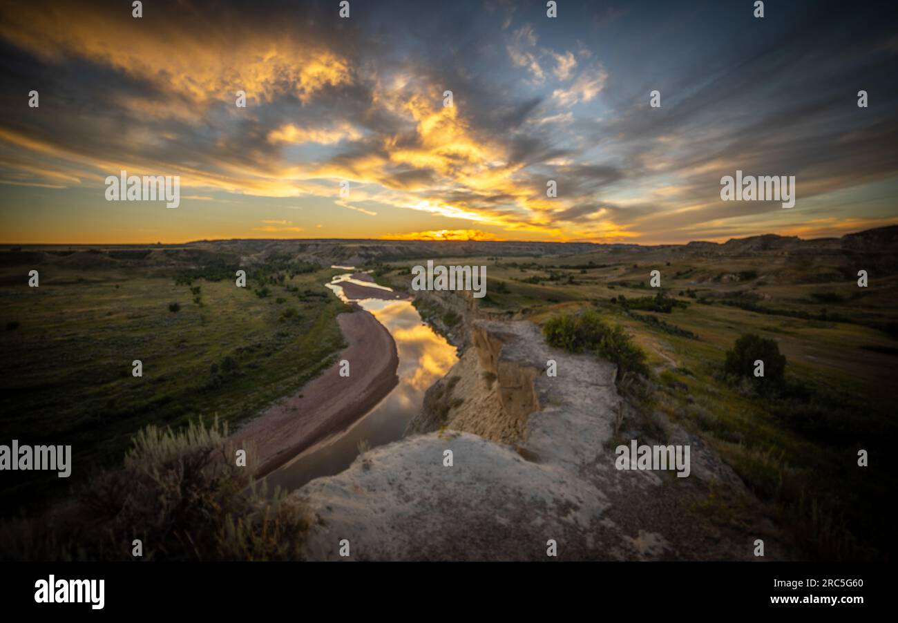 Sunset with colorful clouds and reflection at Wind Canyon and Little Missouri River | Theodore Roosevelt National Park, North Dakota, USA Stock Photo