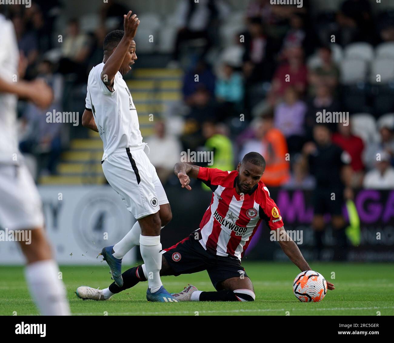 Boreham Wood's Angelo Balanta (left) and Brentford's Rico Henry battle for the ball during a friendly match at LV BET Stadium Meadow Park, Borehamwood. Picture date: Wednesday July 12, 2023. Stock Photo