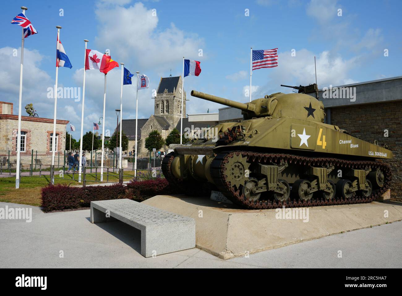 US Sherman Tank outside The Airborne Museum with The Church Behind. Sainte Mere Eglise, France Stock Photo