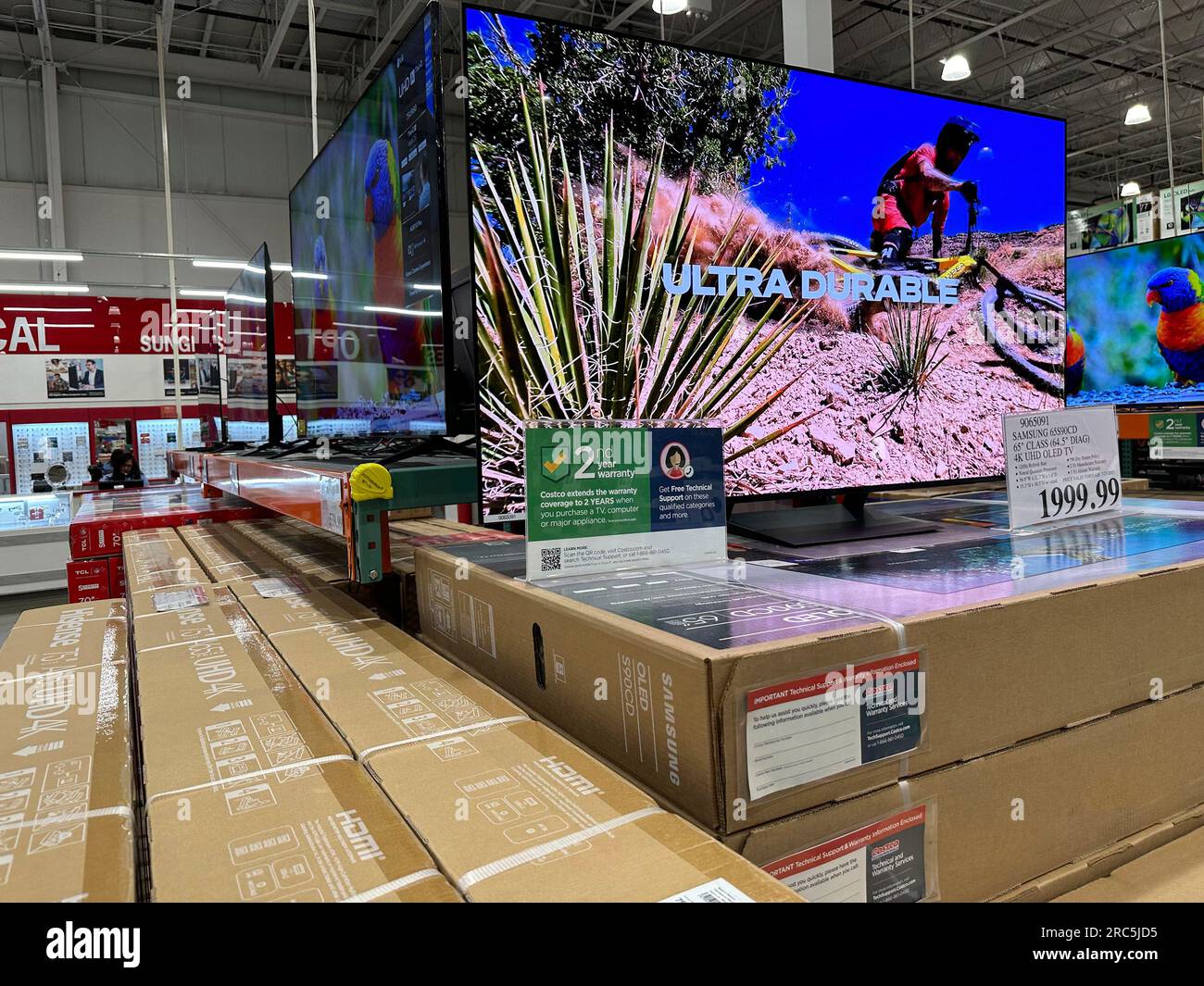 Bigscreen televisions sit on display in a Costco warehouse Tuesday