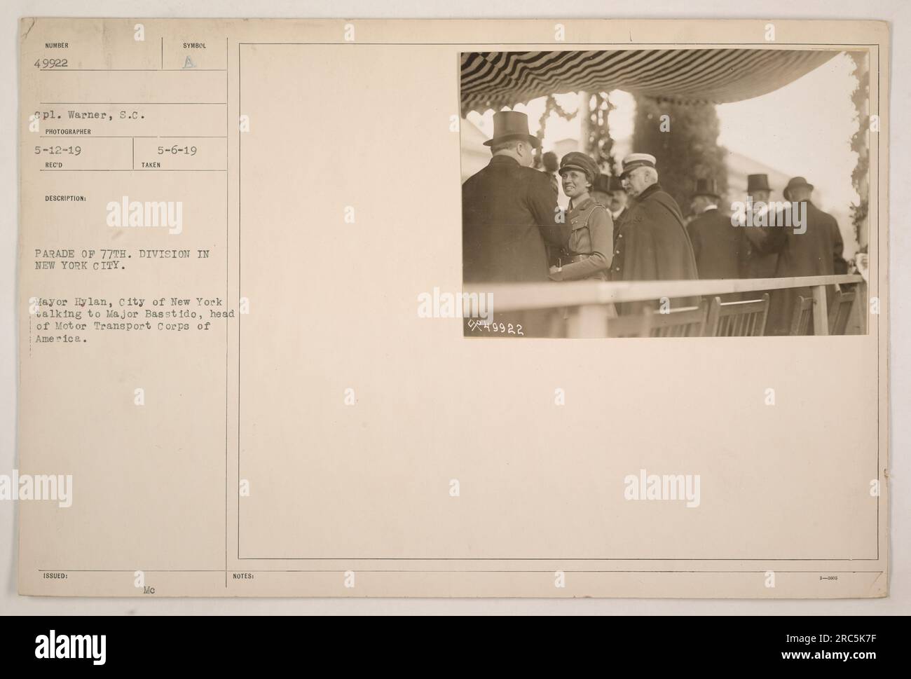Mayor Hylan of New York City talking to Major Basstido, head of the Motor Transport Corps of America during the parade of the 77th Division in New York City. The photograph was taken on May 12, 1919, by CPL. Warner, 8.C. Photographer, with the Army symbol issued on May 6, 1919. Stock Photo