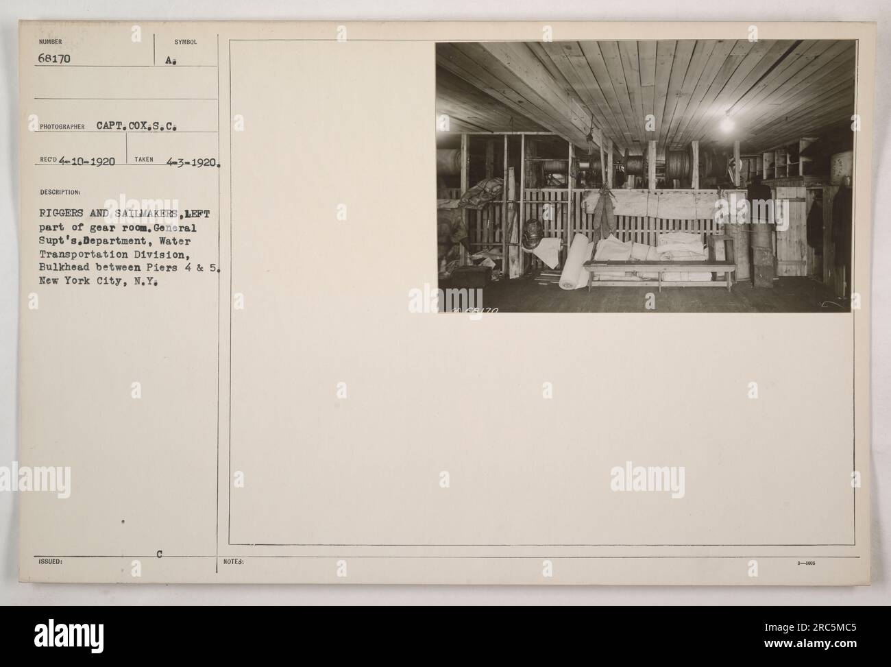 This photograph depicts riggers and sailmakers working in the left part ...
