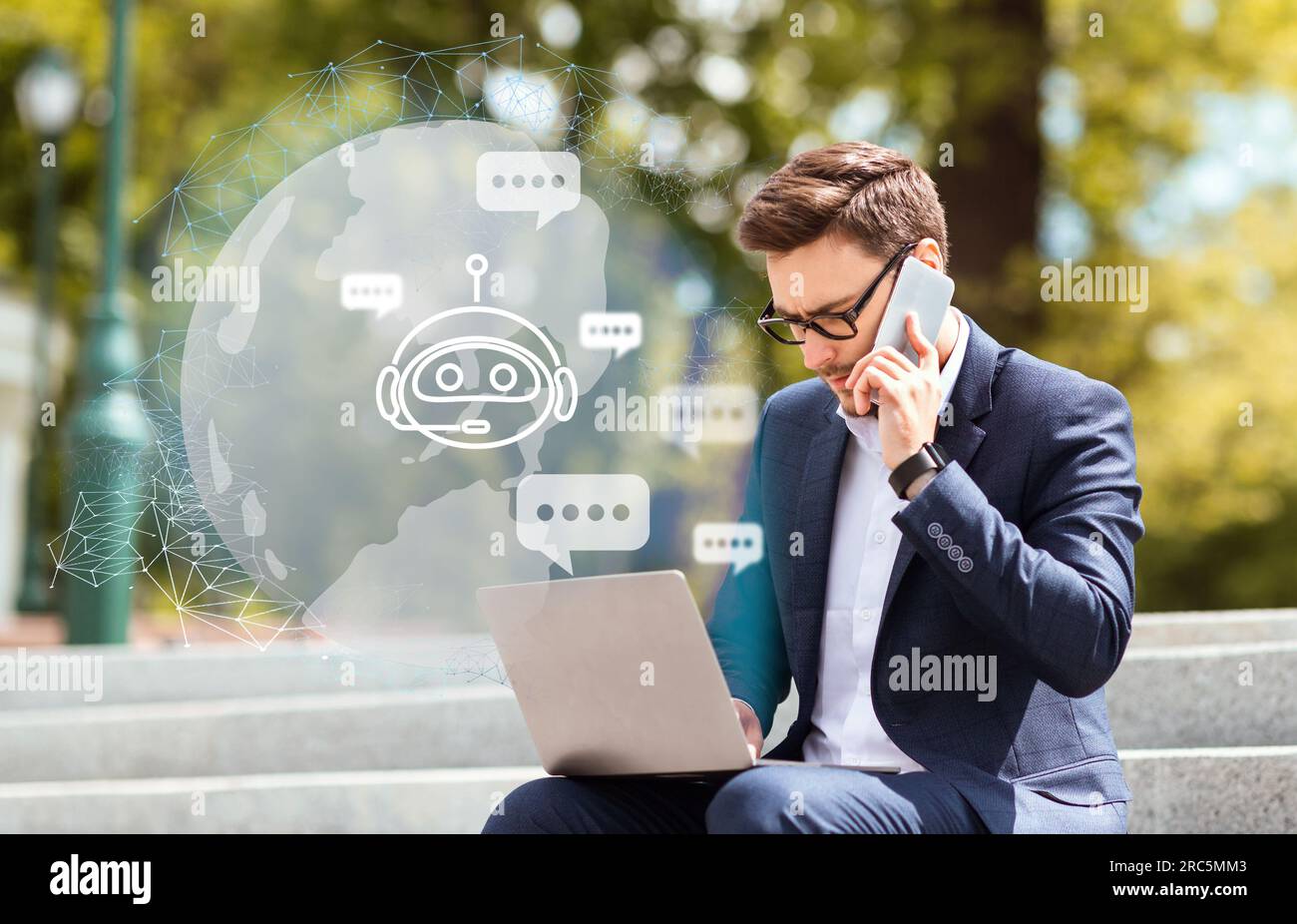 Young guy entrepreneur typing on laptop keyboard, using chatbot Stock Photo
