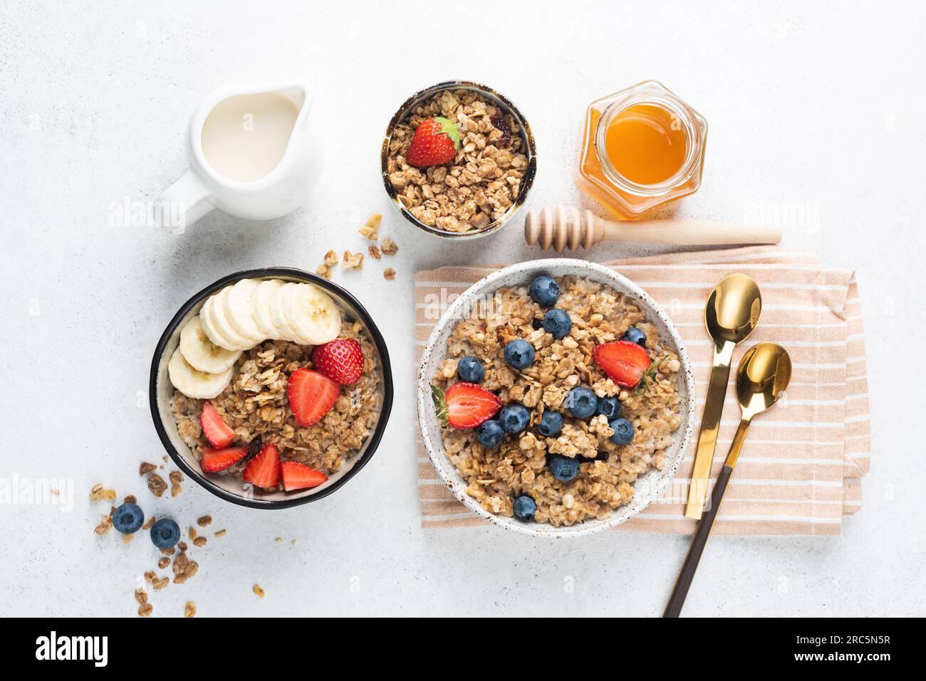 Granola with berries, banana and almond milk on a table, top view. Flat lay composition Stock Photo