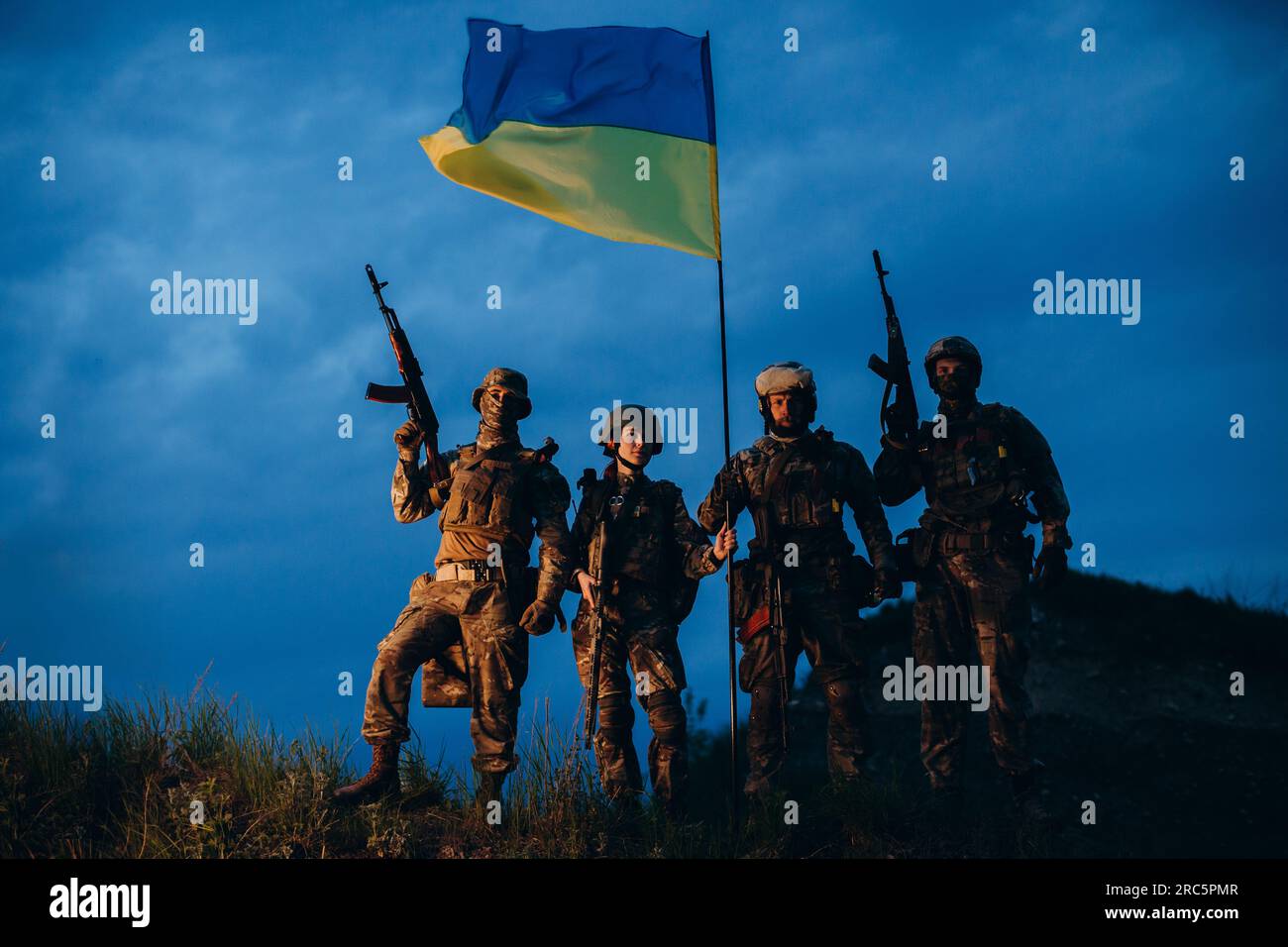 Portrait of Ukrainian armed forces with a national flag in the evening ...