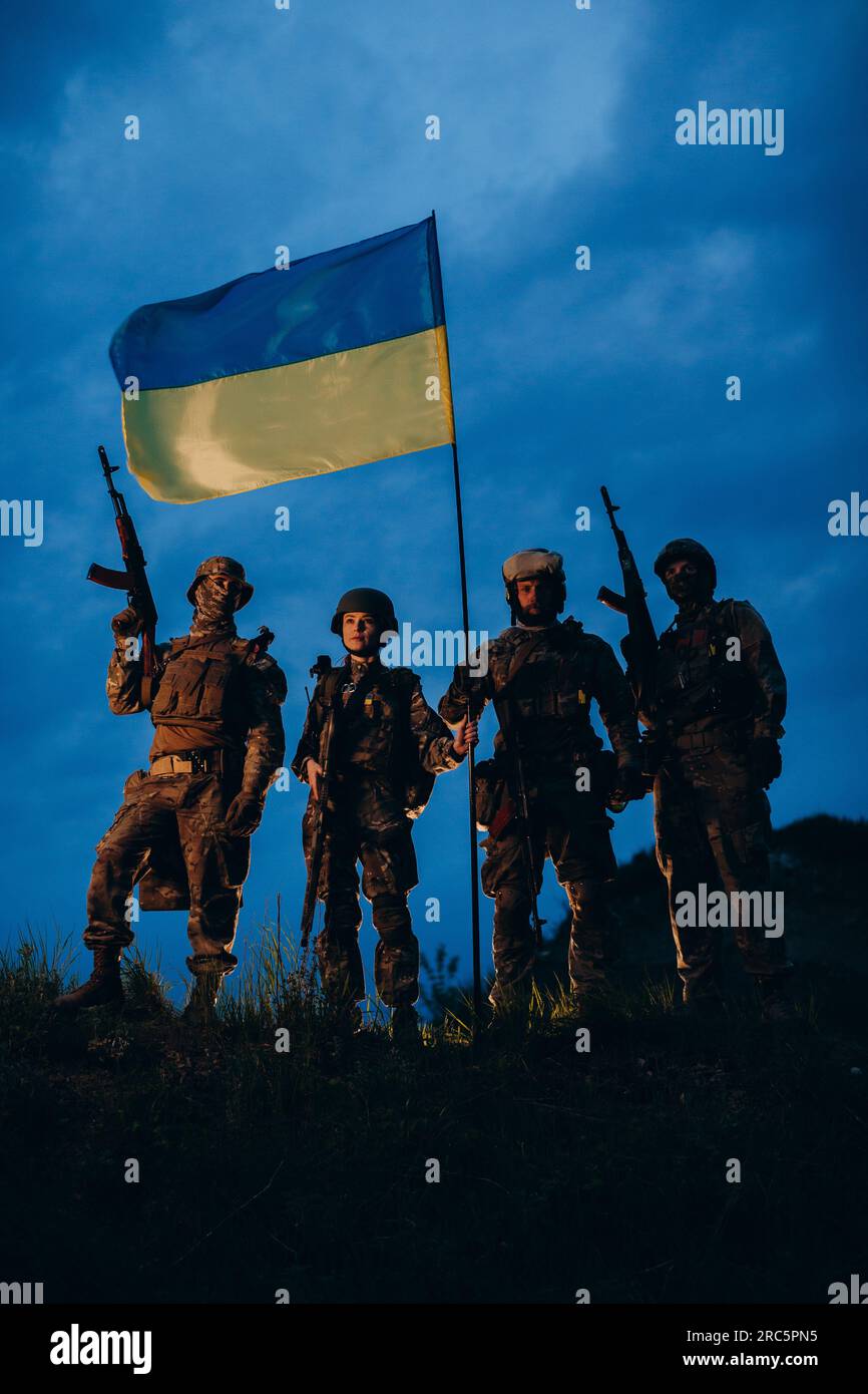Company of Ukrainian armed forces with blue and yellow flag in the ...