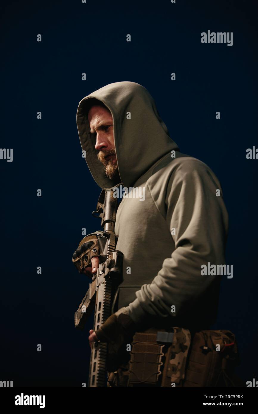 Ukrainian defender holding his rifle on a dark background Stock Photo ...