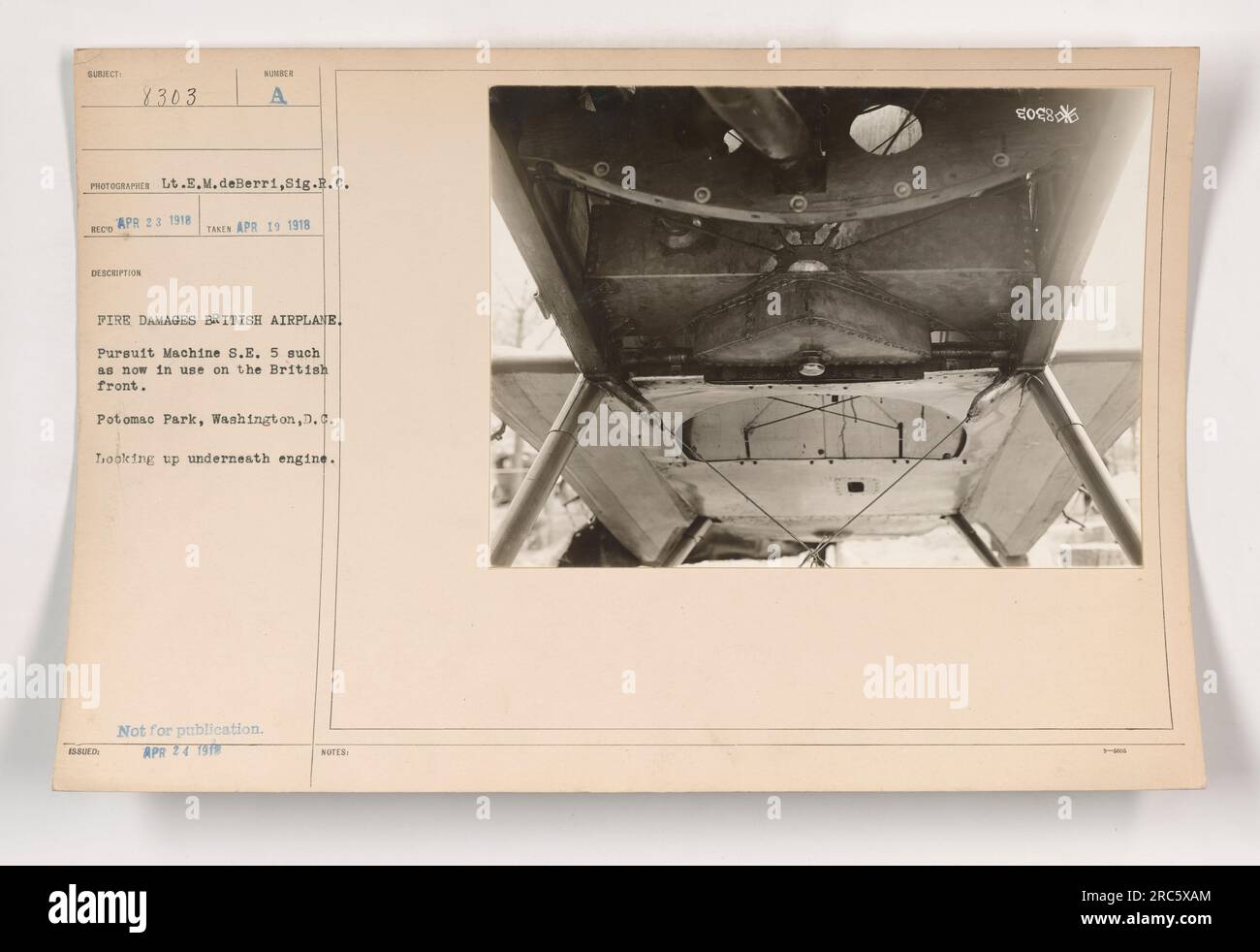 Photograph depicting a British pursuit machine S.E. 5, damaged by fire on April 19, 1918. Lt. E.M. deBerri, Sig. R.C. took the photo on April 23, 1918, in Potomac Park, Washington, D.C. The image shows a view underneath the engine and was not intended for publication. Stock Photo