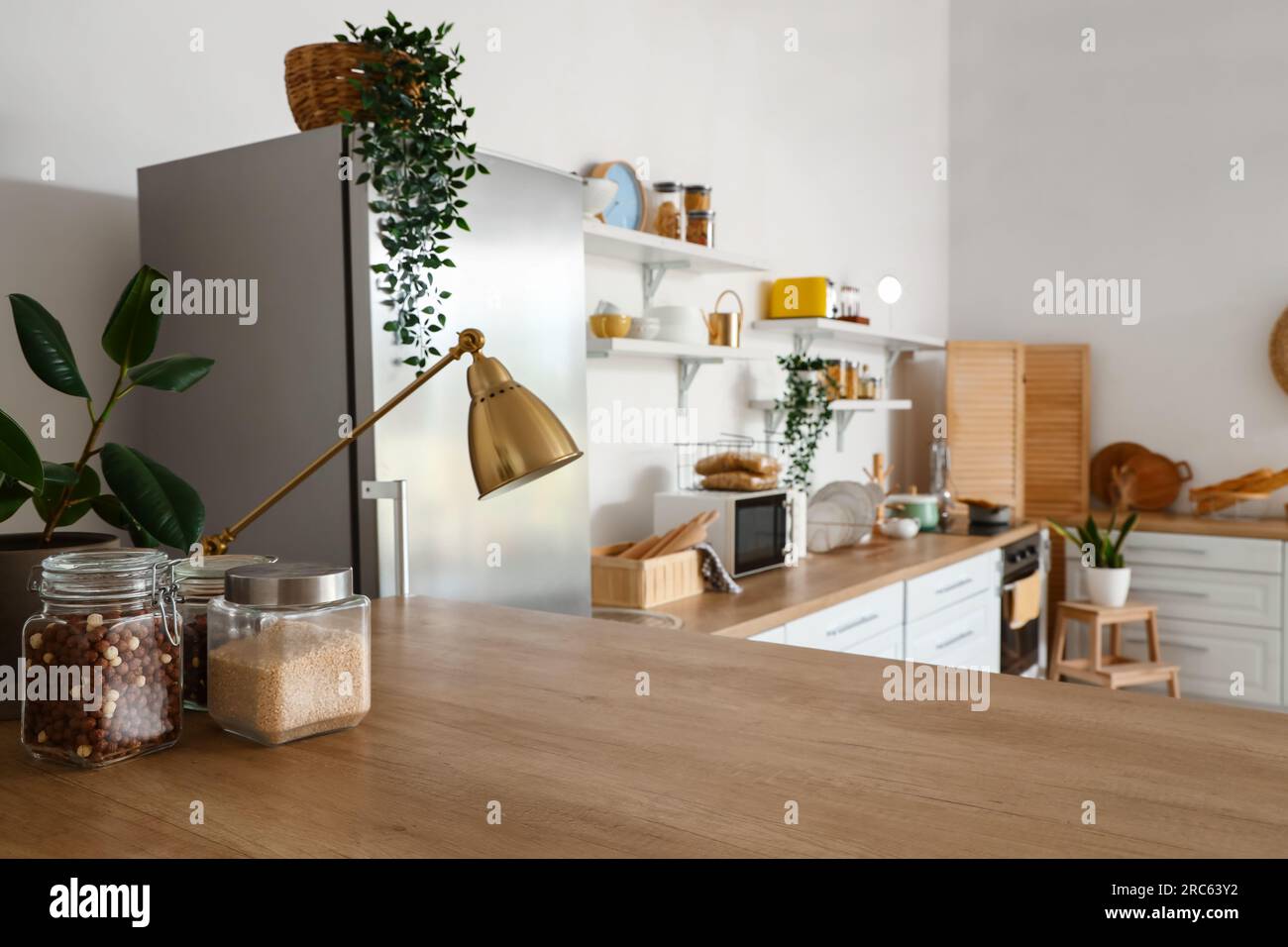 Interior of light kitchen with stylish fridge, counters and shelves ...