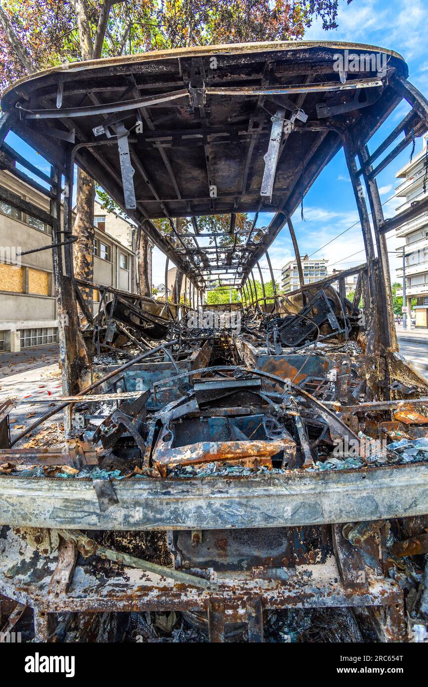 Destroyed burnt-out bus after riot demonstration on Rue Grammont in city center - Tours, Indre-et-Loire (37), France. Stock Photo