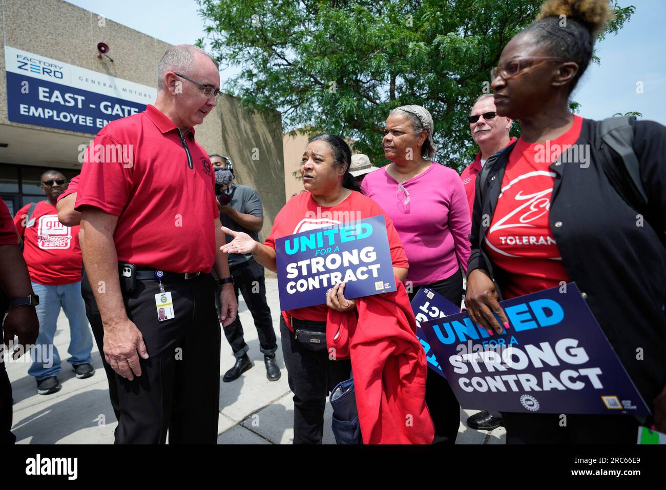 United Auto Workers president Shawn Fain, left, talks with autoworkers ...
