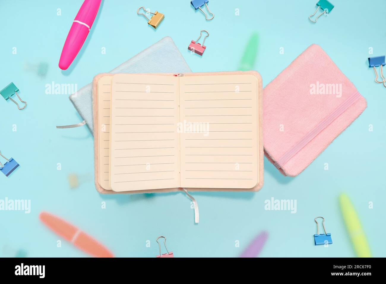 Blank notebook with stationery on blue background Stock Photo