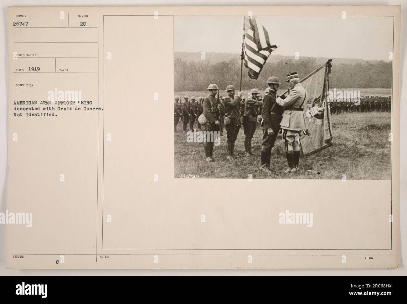 American army officer being decorated with the Croix de Guerre, an honor awarded for acts of valor during World War One. The identity of the officer in the photograph is unknown. Stock Photo