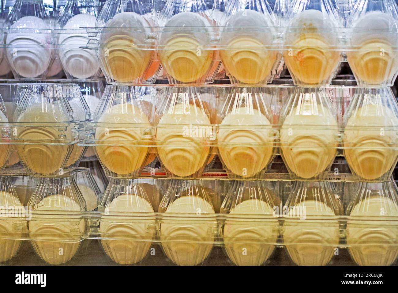 background of chicken eggs packed in a plastic transparent container. Economic crisis. rise in price Stock Photo