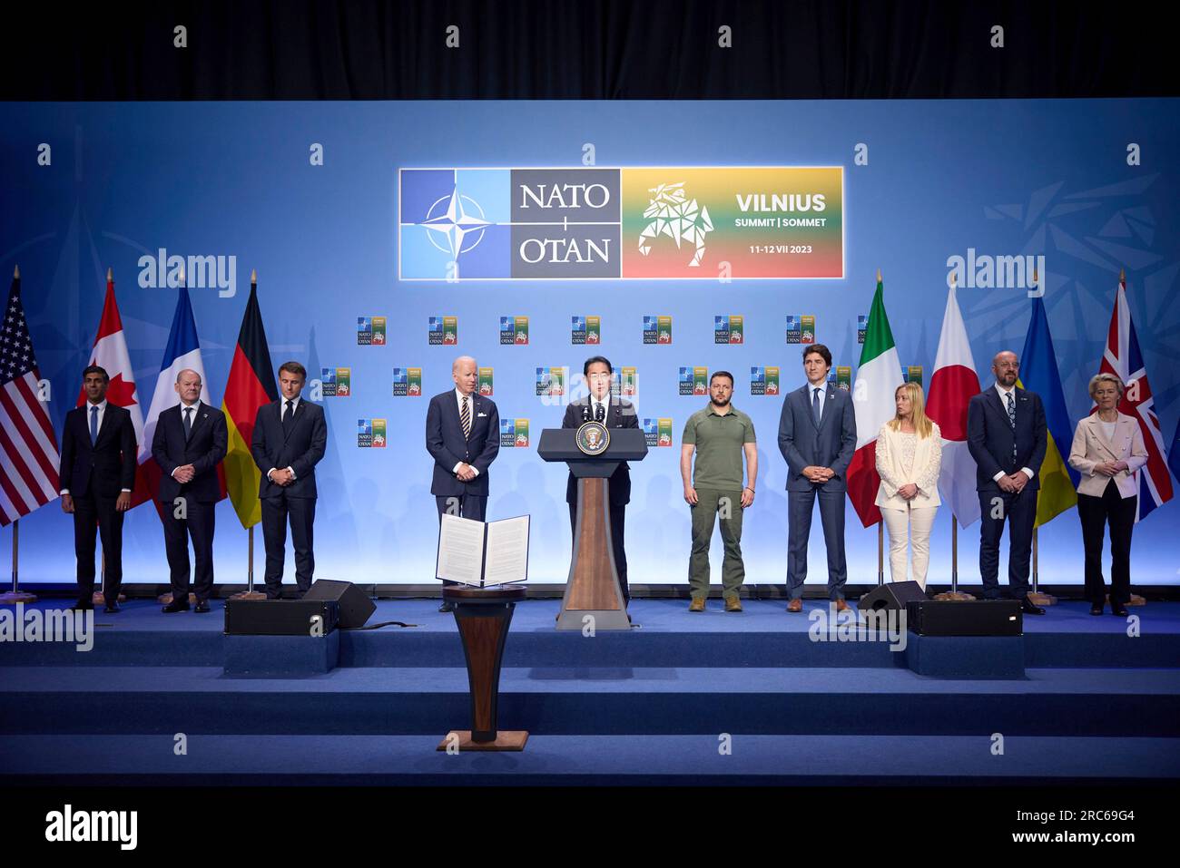 Vilnius, Lithuania. 12 July, 2023. Japanese Prime Minister Fumio Kishida, center, delivers remarks during an event with G7 leaders to announce a Joint Declaration of Support for Ukraine during the NATO Summit at the Lithuanian Exhibition and Congress Center, July 12, 2023 in Vilnius, Lithuania. Standing from left: British Prime Minister Rishi Sunak, German Chancellor Olaf Schotz, French President Emmanuel Macron, Japanese Prime Minister Fumio Kishida, U.S. President Joe Biden, Ukrainian President Volodymyr Zelenskyy, Canadian Prime Minister Justin Trudeau, Italian Prime Minister Giorgia Meloni Stock Photo