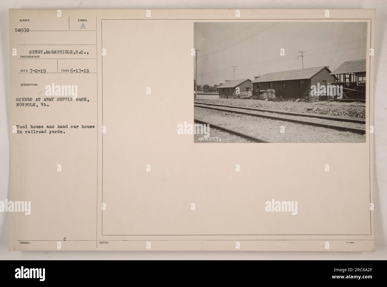 A tool house and hand car house are seen in the railroad yards of the