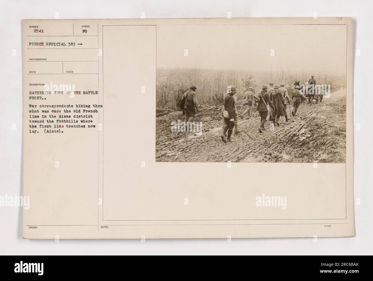 War correspondents hiking through the former French line in the Aisne district, gathering news at the battlefront. This image shows the journalists en route to the foothills where the first line trenches are now located. Stock Photo