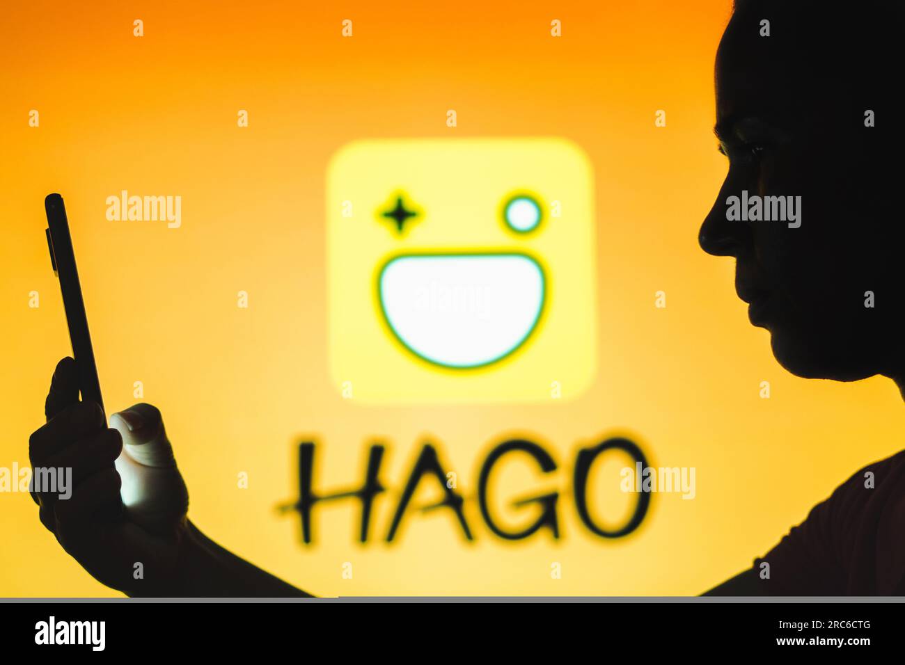 Brazil. 12th July, 2023. In this photo illustration, a person holds a smartphone with the Hago logo in the background. (Credit Image: © Rafael Henrique/SOPA Images via ZUMA Press Wire) EDITORIAL USAGE ONLY! Not for Commercial USAGE! Stock Photo