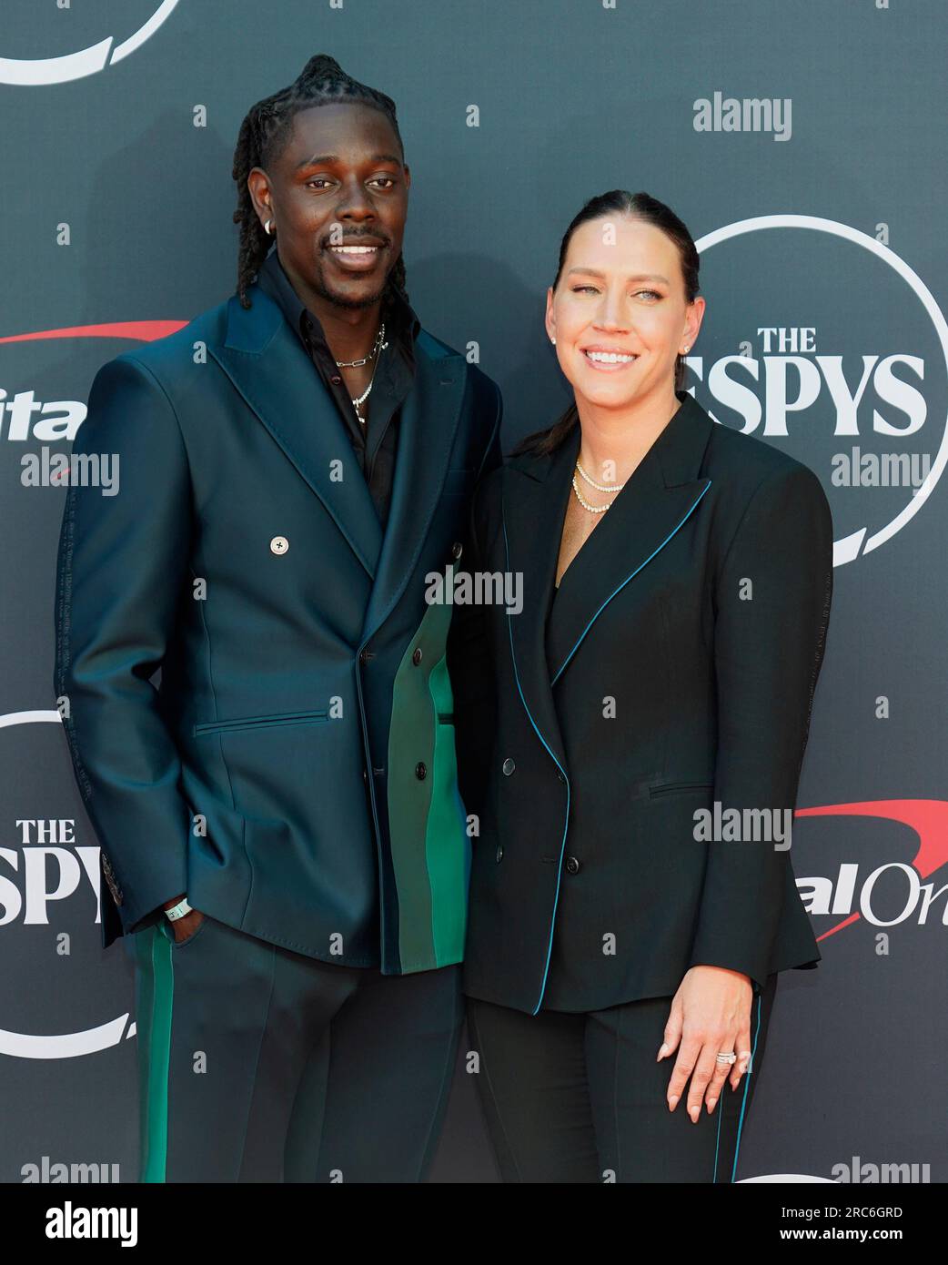 Professional NBA basketball player Jrue Holiday, of the Milwaukee Bucks, left, and former