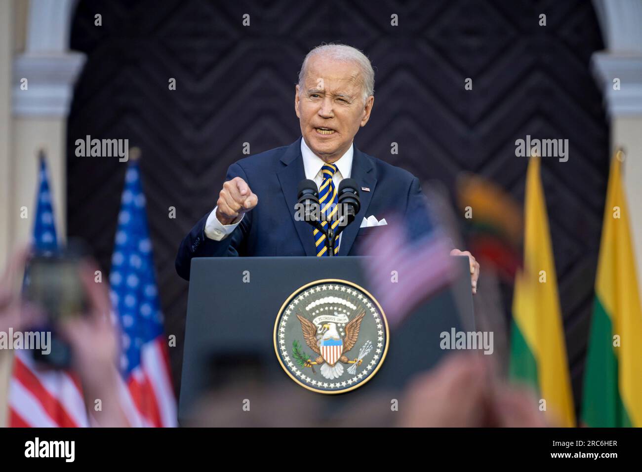 Vilnius, Lithuania. 12th July, 2023. U.S President Joe Biden delivers an address to the Lithuanian and Ukrainian nations refusing to bow to Russian aggression at Vilnius University following the NATO Summit, July 12, 2023 in Vilnius, Lithuania. An estimated crowd of 10,000 people waved Lithuanian, American and Ukrainian flags and cheered the president. Credit: Adam Schultz/White House Photo/Alamy Live News Stock Photo