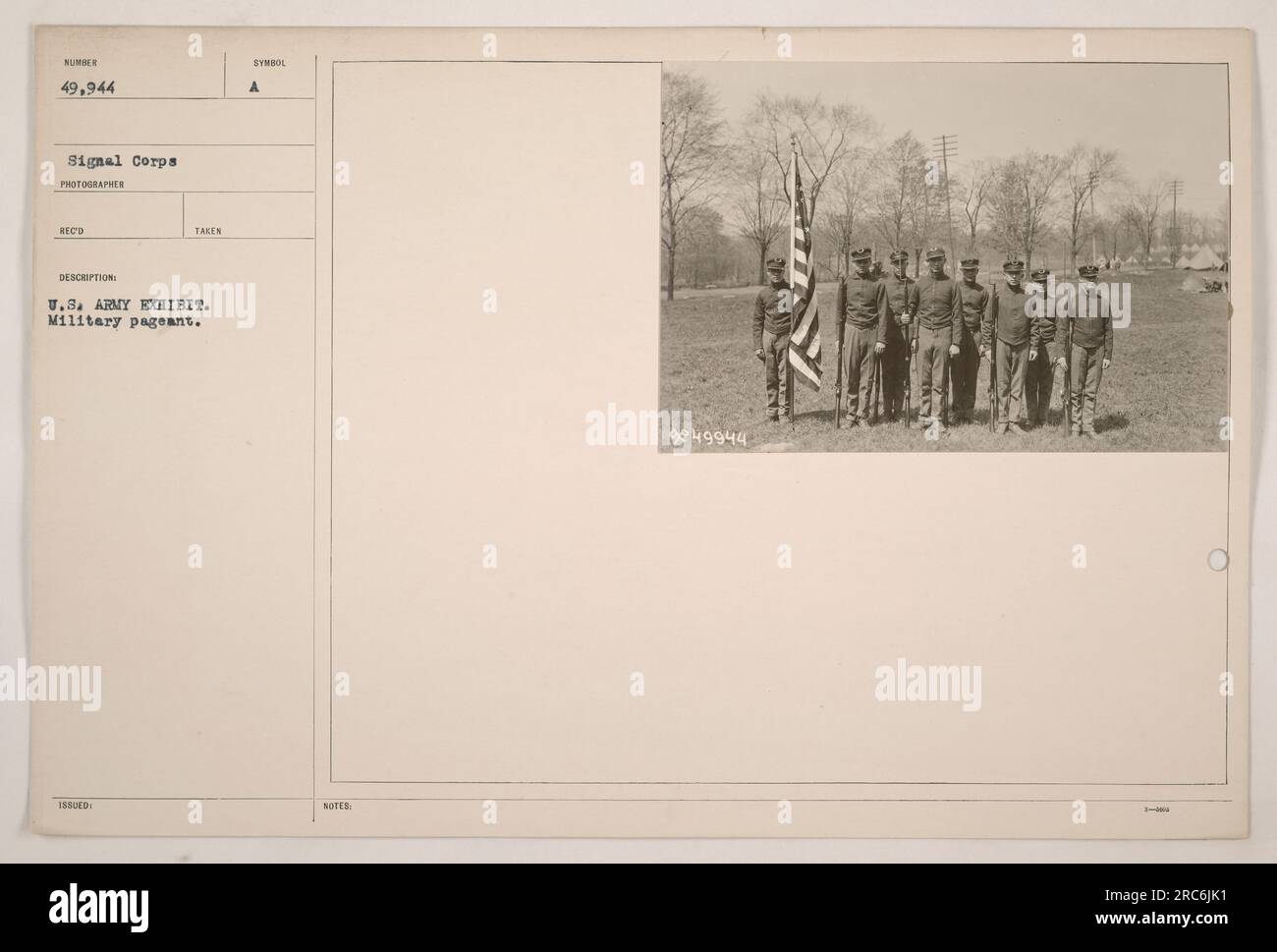 US Army soldiers parading during a military exhibition. Photograph taken by a photographer from the Signal Corps. The image is labeled as US Army Exhibit, Military Pageant, with a catalog number of 49944. Stock Photo