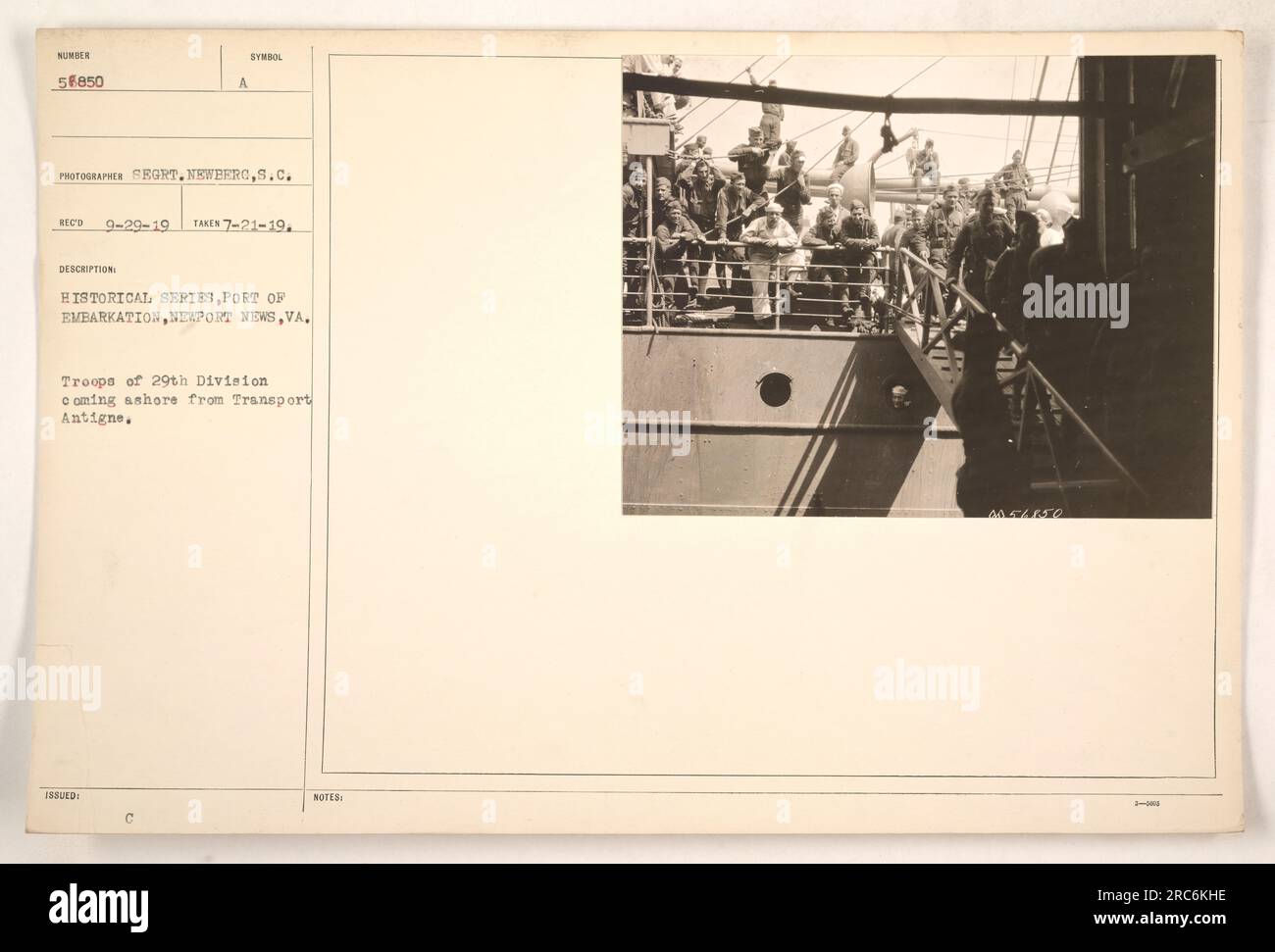 Troops of the 29th Division disembark from the Transport Antigne at the Port of Embarkation in Newport News, VA. This photograph was taken on July 21, 1919, and is part of a historical series. The image depicts a significant moment in American military activities during World War I. Stock Photo