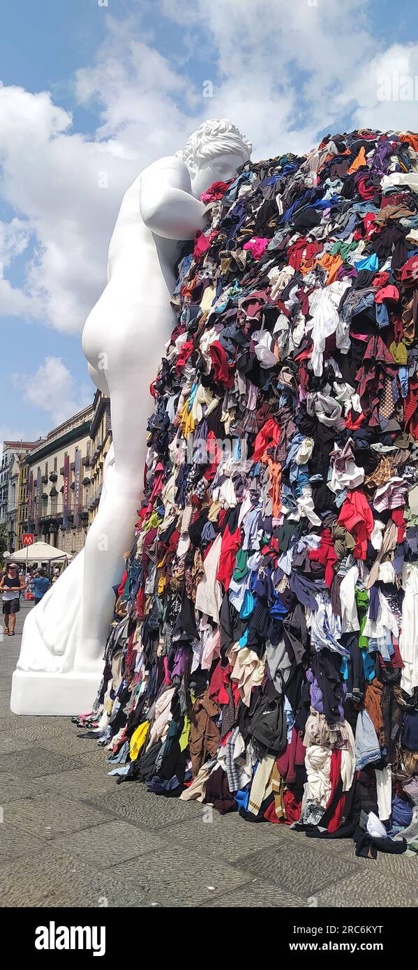 Naples, 12/07/2023, On the night between Tuesday and Wednesday, a fire destroyed the art installation Venus of Rags, by Michelangelo Pistoletto, which from June 28 was exposed in Piazza Municipio, in the center of Naples. The installation is one of the most famous works of Pistoletto, one of the most famous contemporary Italian artists of the current 'arte povera'. The burning installation was about 10 meters high and, in addition to the statue of Venus made of plaster and resin, consisted of a metal scaffold covered with rags. The images date back to a few days before the fire and show crowds Stock Photo