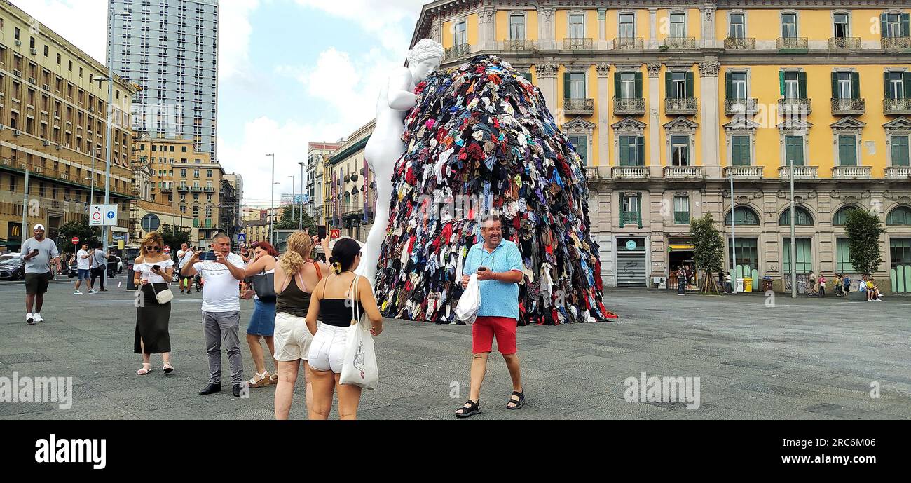 Naples, 12/07/2023, On the night between Tuesday and Wednesday, a fire destroyed the art installation Venus of Rags, by Michelangelo Pistoletto, which from June 28 was exposed in Piazza Municipio, in the center of Naples. The installation is one of the most famous works of Pistoletto, one of the most famous contemporary Italian artists of the current 'arte povera'. The burning installation was about 10 meters high and, in addition to the statue of Venus made of plaster and resin, consisted of a metal scaffold covered with rags. The images date back to a few days before the fire and show crowds Stock Photo