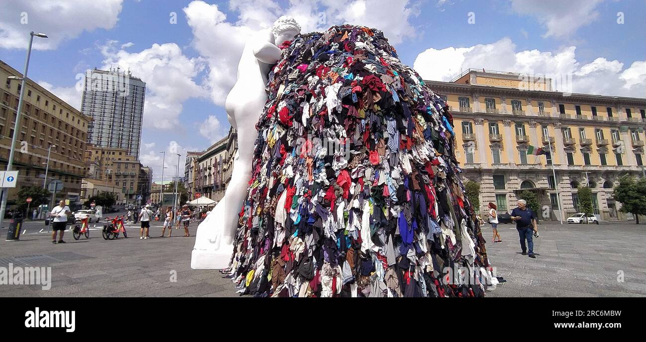 July 12, 2023, Naples, Campania, Italy: On the night between Tuesday and Wednesday, a fire destroyed the art installation Venus of Rags, by Michelangelo Pistoletto, which from June 28 was exposed in Piazza Municipio, in the center of Naples. The installation is one of the most famous works of Pistoletto, one of the most famous contemporary Italian artists of the current ''arte povera''. The burning installation was about 10 meters high and, in addition to the statue of Venus made of plaster and resin, consisted of a metal scaffold covered with rags. The images date back to a few days before th Stock Photo