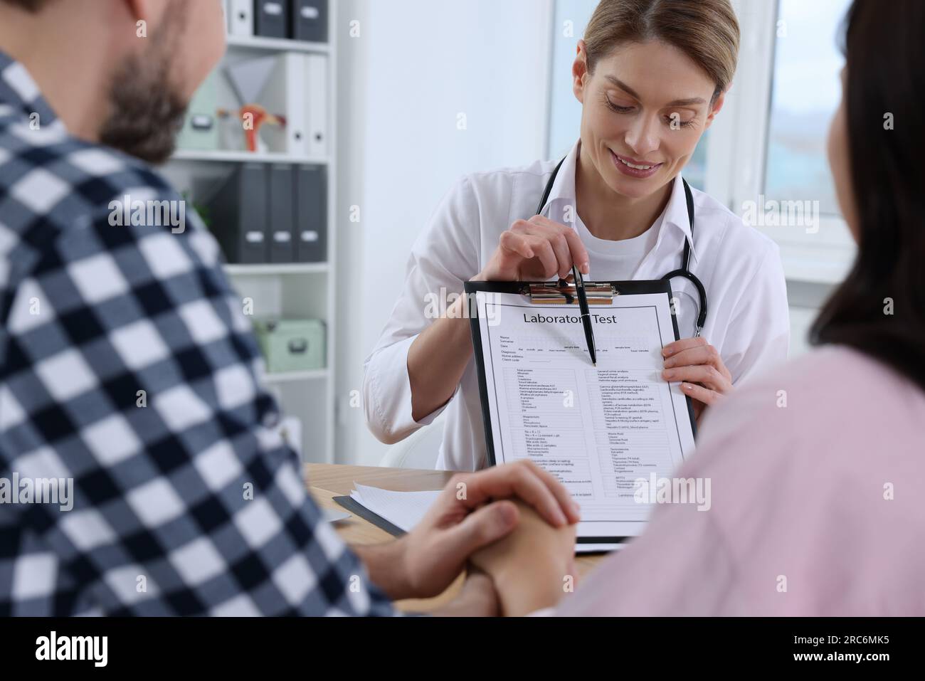 Couple having appointment with fertility doctor in clinic. Patient