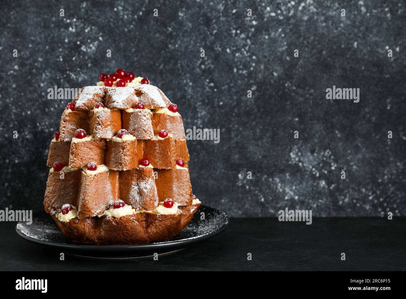 https://c8.alamy.com/comp/2RC6P15/delicious-pandoro-christmas-tree-cake-with-powdered-sugar-and-berries-on-black-table-space-for-text-2RC6P15.jpg