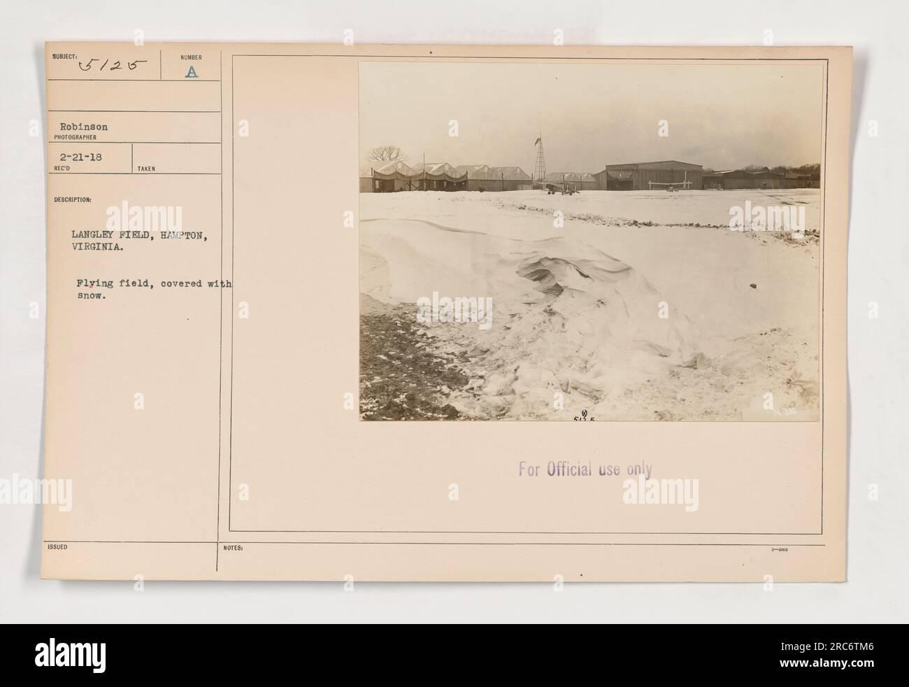 'Aerial view of Humber, a military aircraft, at Langley Field in Hampton, Virginia. The flying field is covered with snow. This photograph was taken on February 21, 1918, by Robinson, and labeled as officially issued and for official use only.' Stock Photo