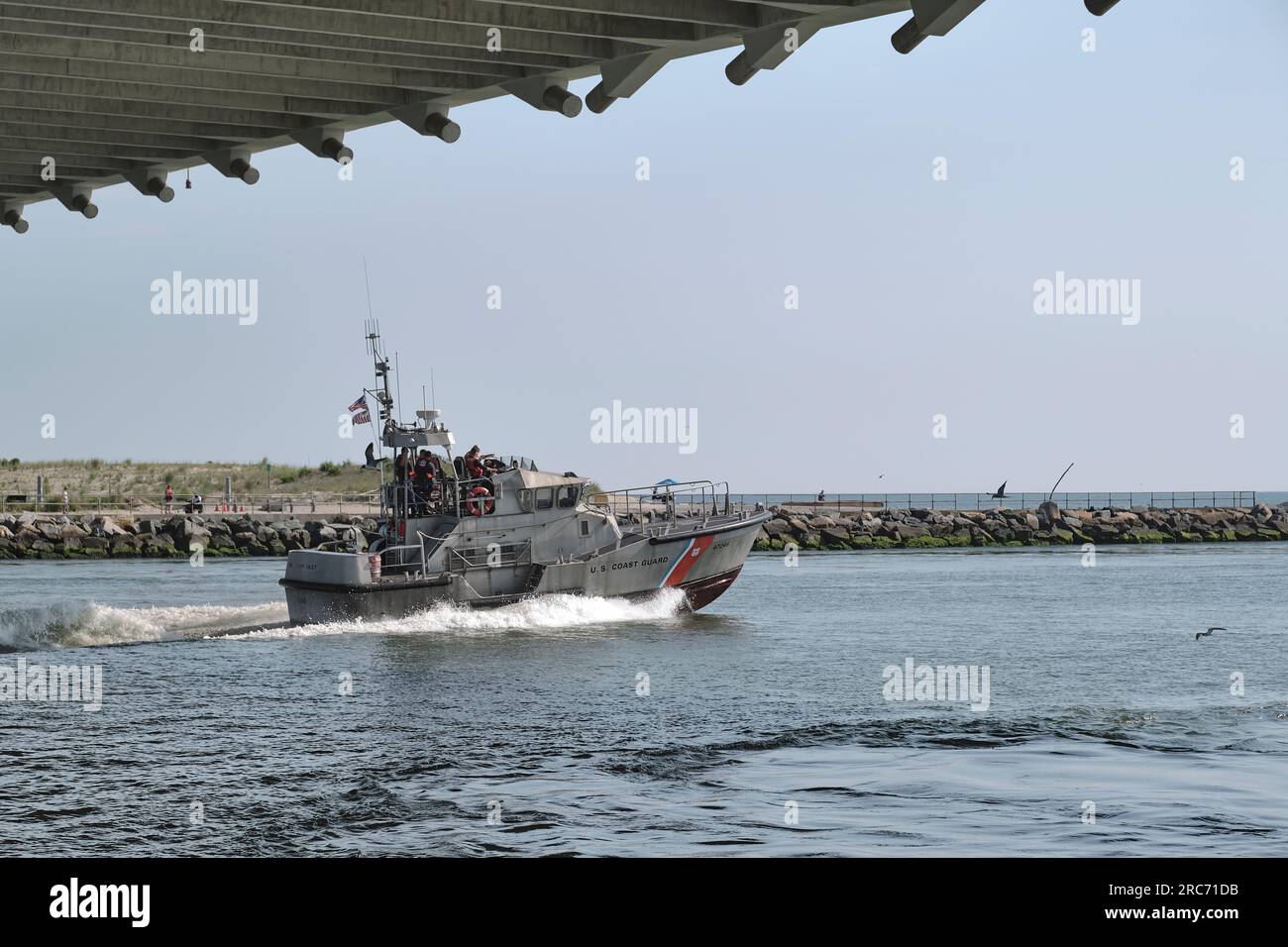 A United States Coast Guard patrol boat heads out to sea on the Indian River Inlet in southern