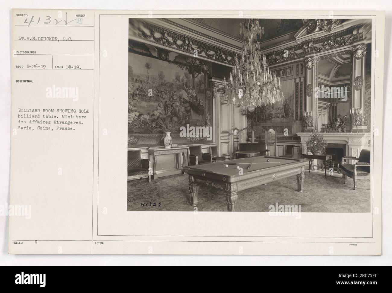 Lt. H.S. Dricker, S.C. is photographed in the Sumber Billiard Room, located in the Ministere des Affaires Etrangeres in Paris, France. The image shows a gold billiard table. This photograph was taken on February 26, 1919. Stock Photo
