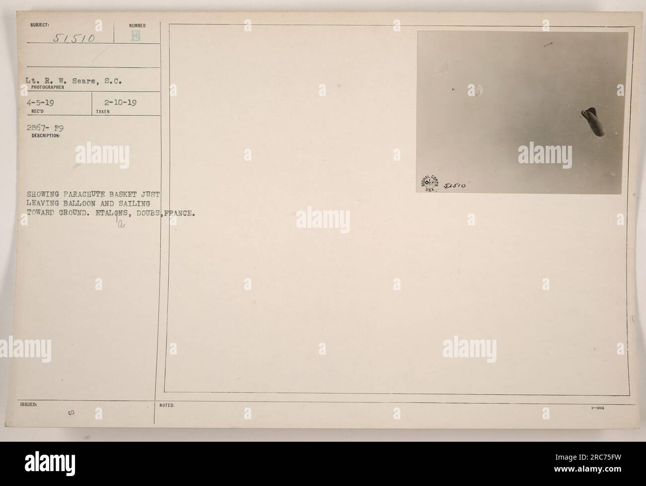 Lt. R. W. Sears captured a photograph on 4-5-19 at Etalons, Doubs, France. The image shows a parachute basket detaching from a balloon and descending towards the ground. This photo was received on 2967-19 and described as 'Issued 00.' The corresponding notes for this image are labeled as 51510. Stock Photo
