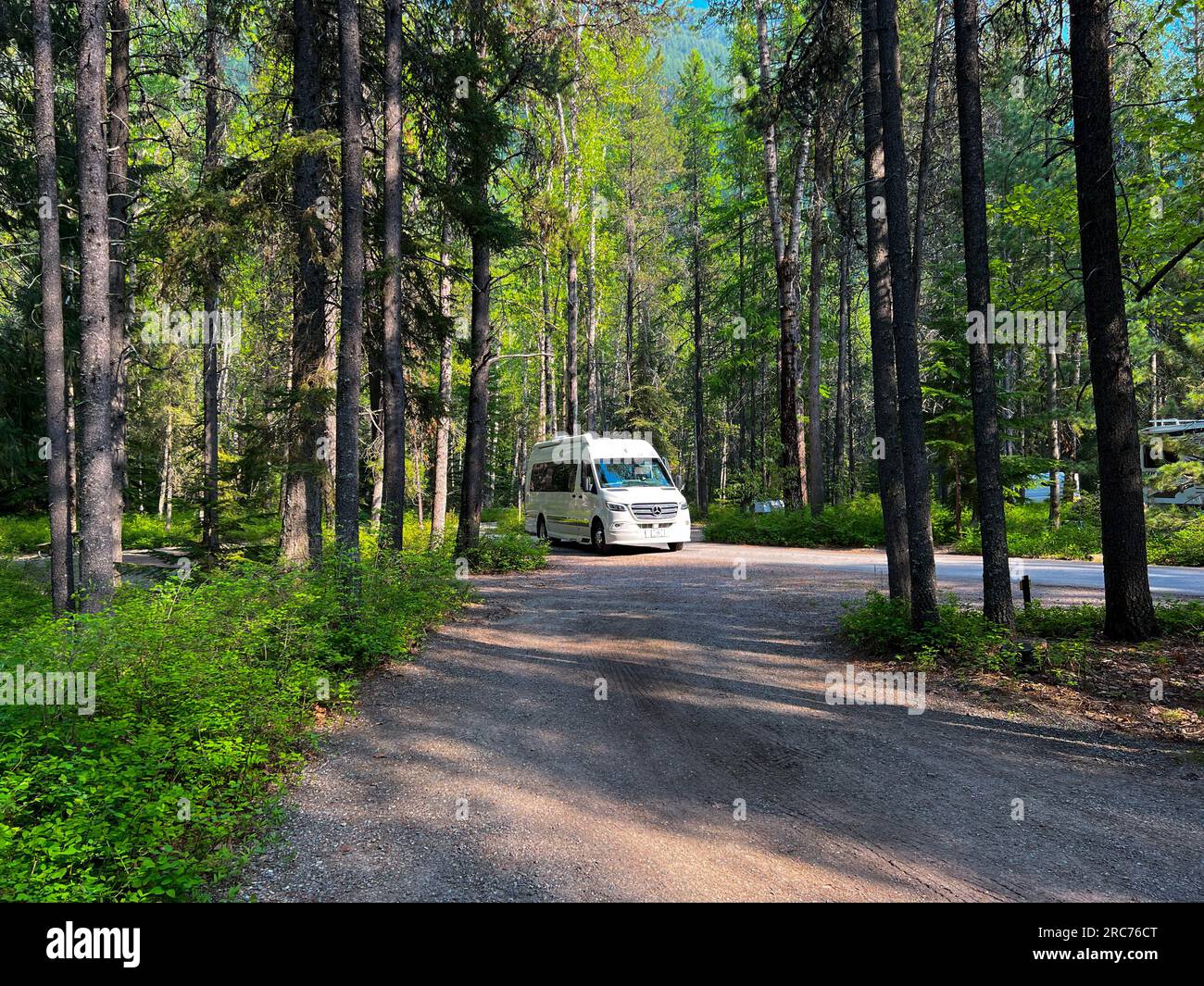 West Glacier, MT USA May 19, 2023 A Camper Van driving through Apgar