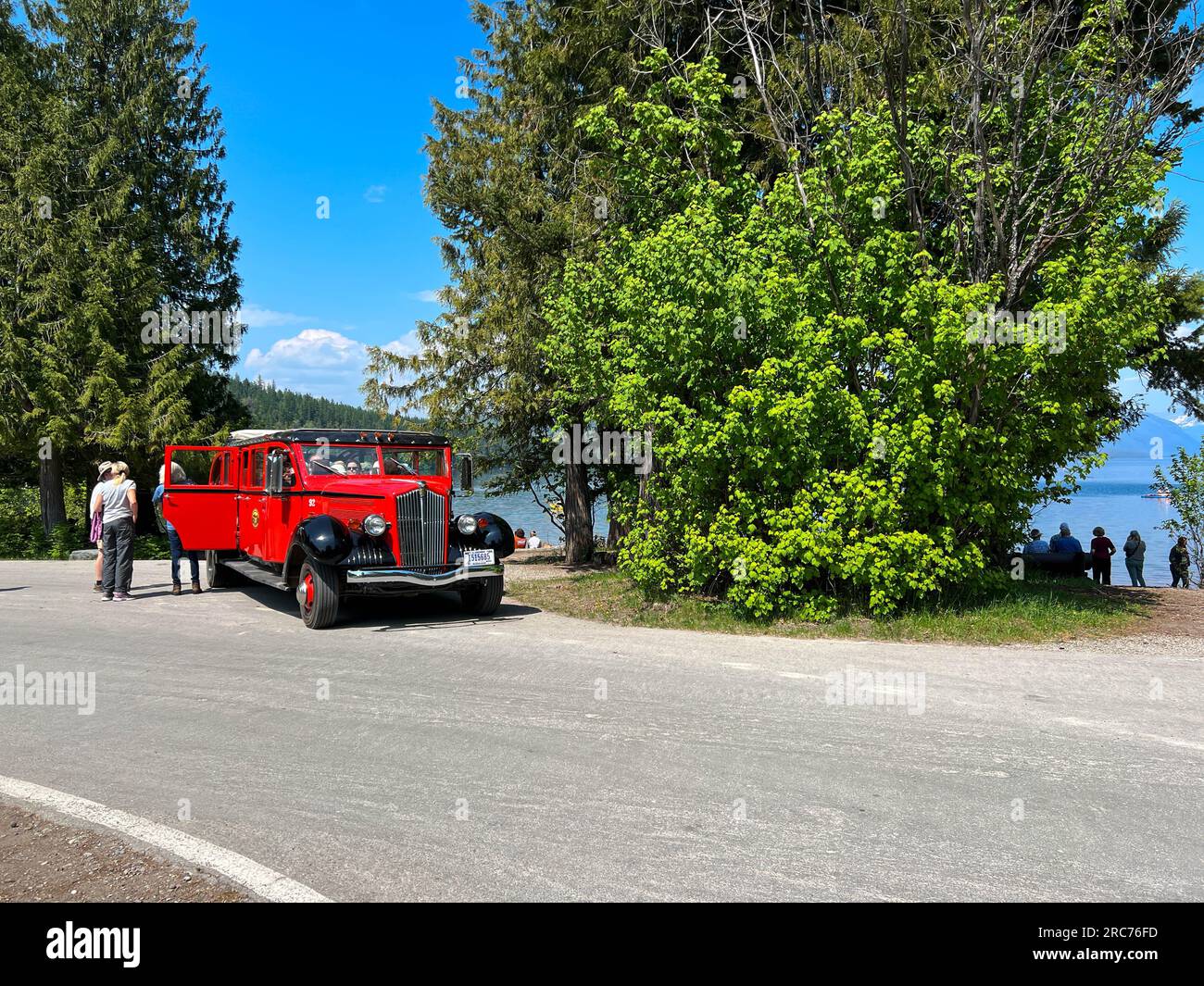 West Glacier, MT USA - May 19, 2023:  A vintage looking tour bus in Glacier National Park near Lake McDonald and Apgar Campground. Stock Photo
