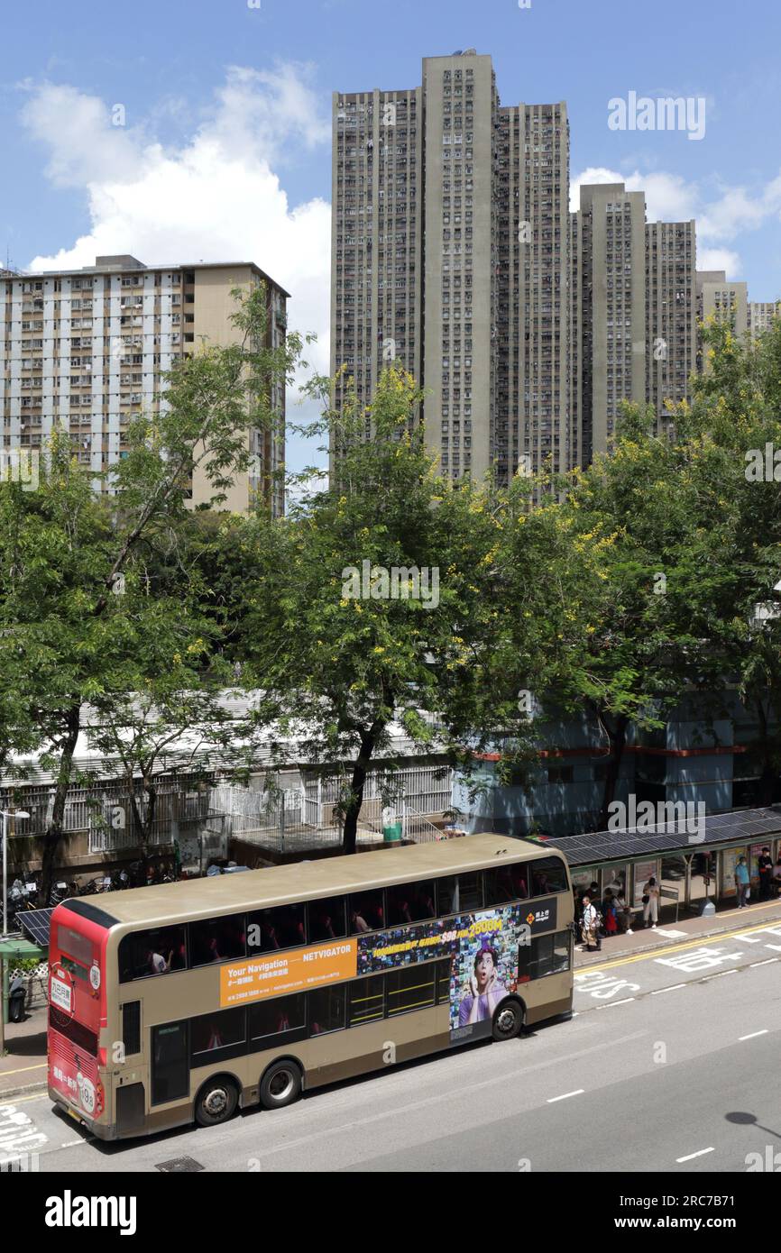 Vertical view of a Kowloon Motor Bus (KMB) and background of Choi Yuen Public Housing Estate, San Wan Road, Sheung Shui, New Territories, Hong Kong Stock Photo