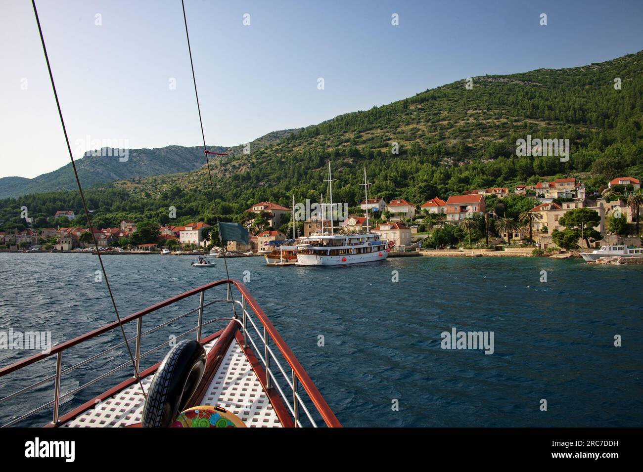 Railing on cruise sailing boat entering the Mediterranean town Stock Photo