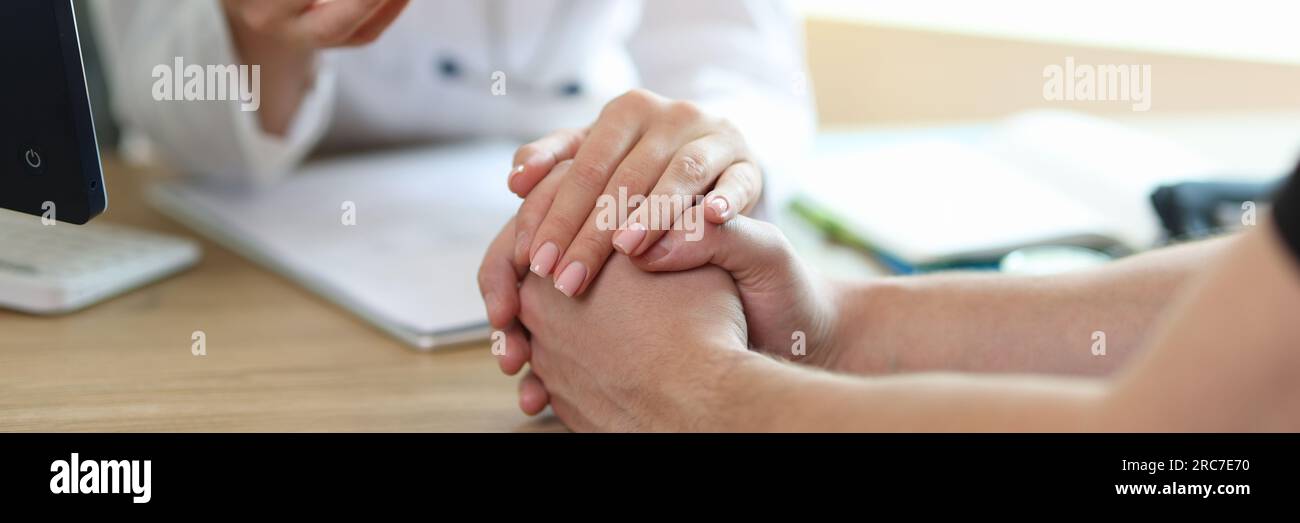 Female doctor in white medical uniform consulting male patient in ...