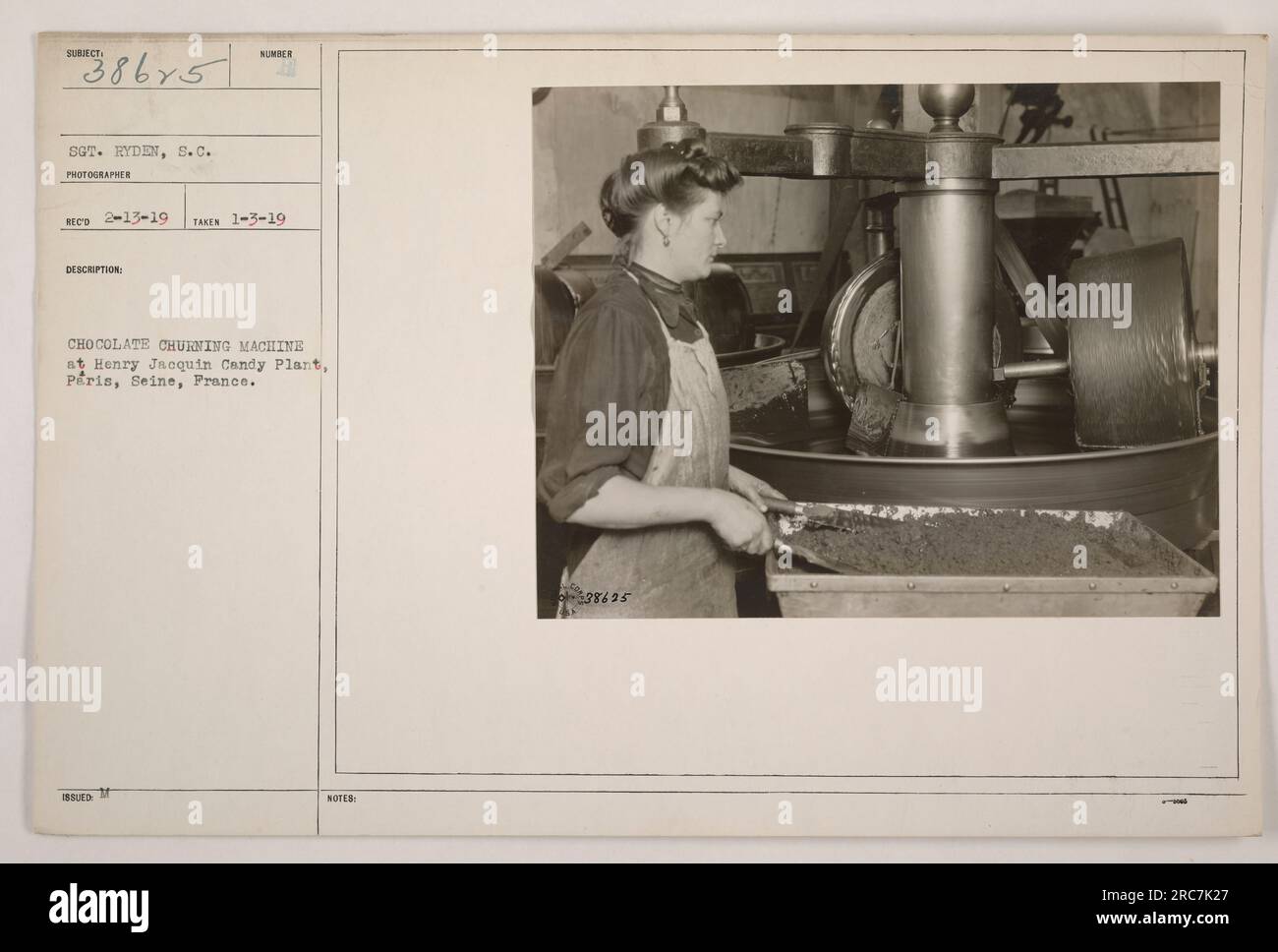 Sgt. Ryden captured an image on 1-3-19 of a chocolate churning machine at the Henry Jacquin Candy Plant in Peris, Seine, France. This photograph is marked with the label 111-SC-38625 and shows the photographer's Subiect as S.C. Stock Photo