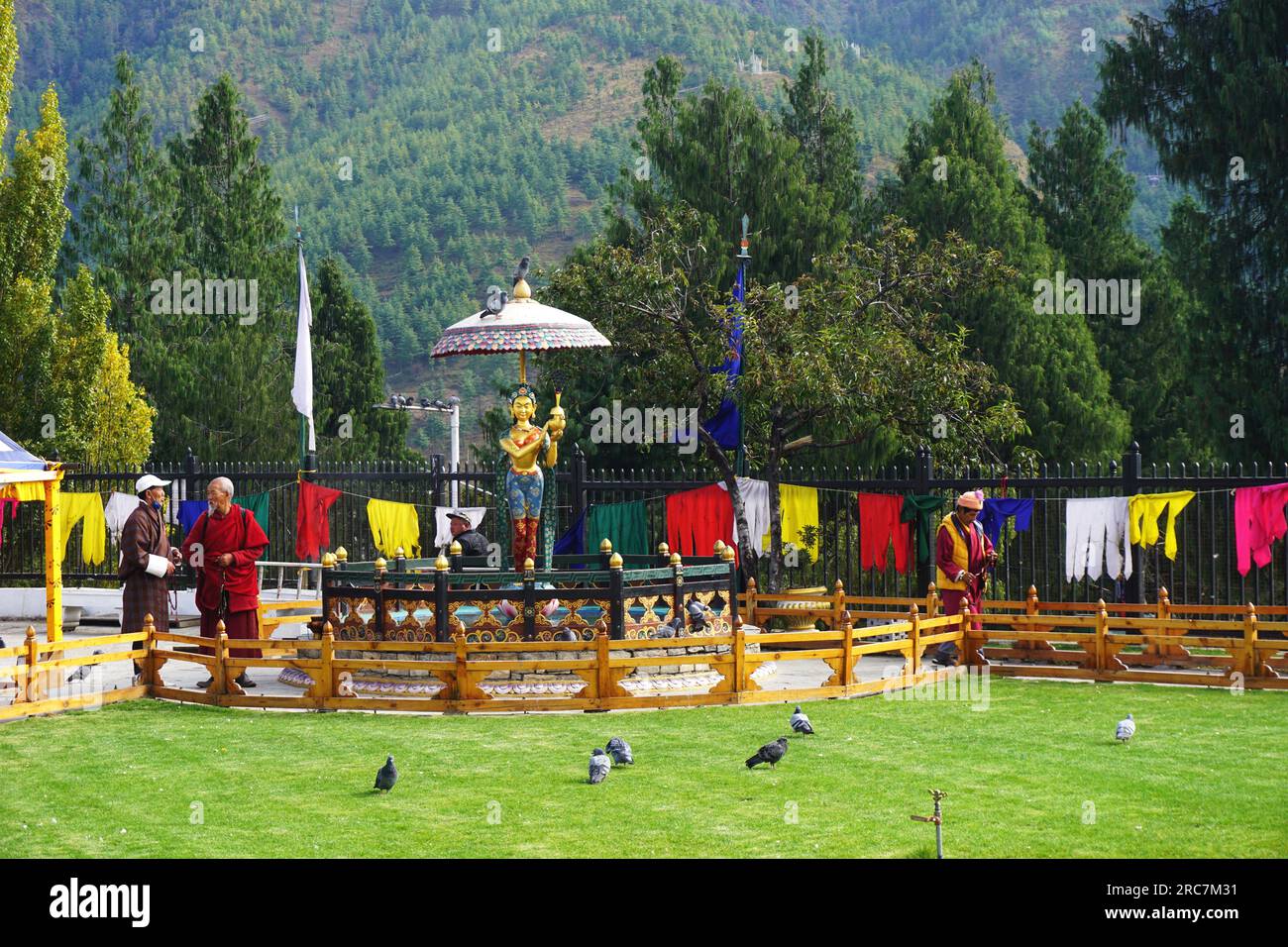 Visitors stop to talk on the grounds of the National Memorial Chorten, Thimphu, Bhutan. Residents come every day to chant prayers as they walk around Stock Photo