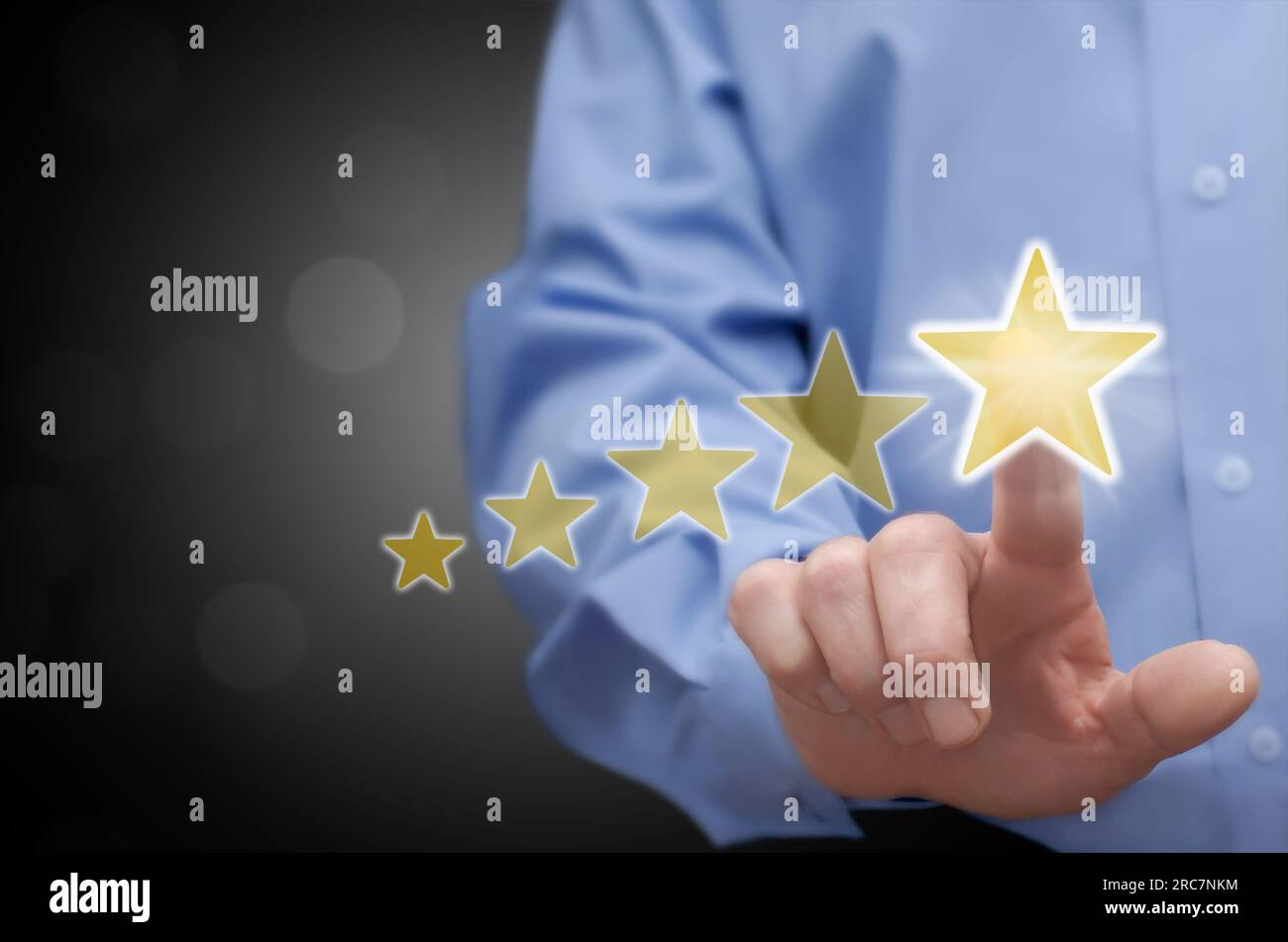 The man touches the five-star rating (vote) icon with his finger. Customer and consumer feedback concept. Stock Photo