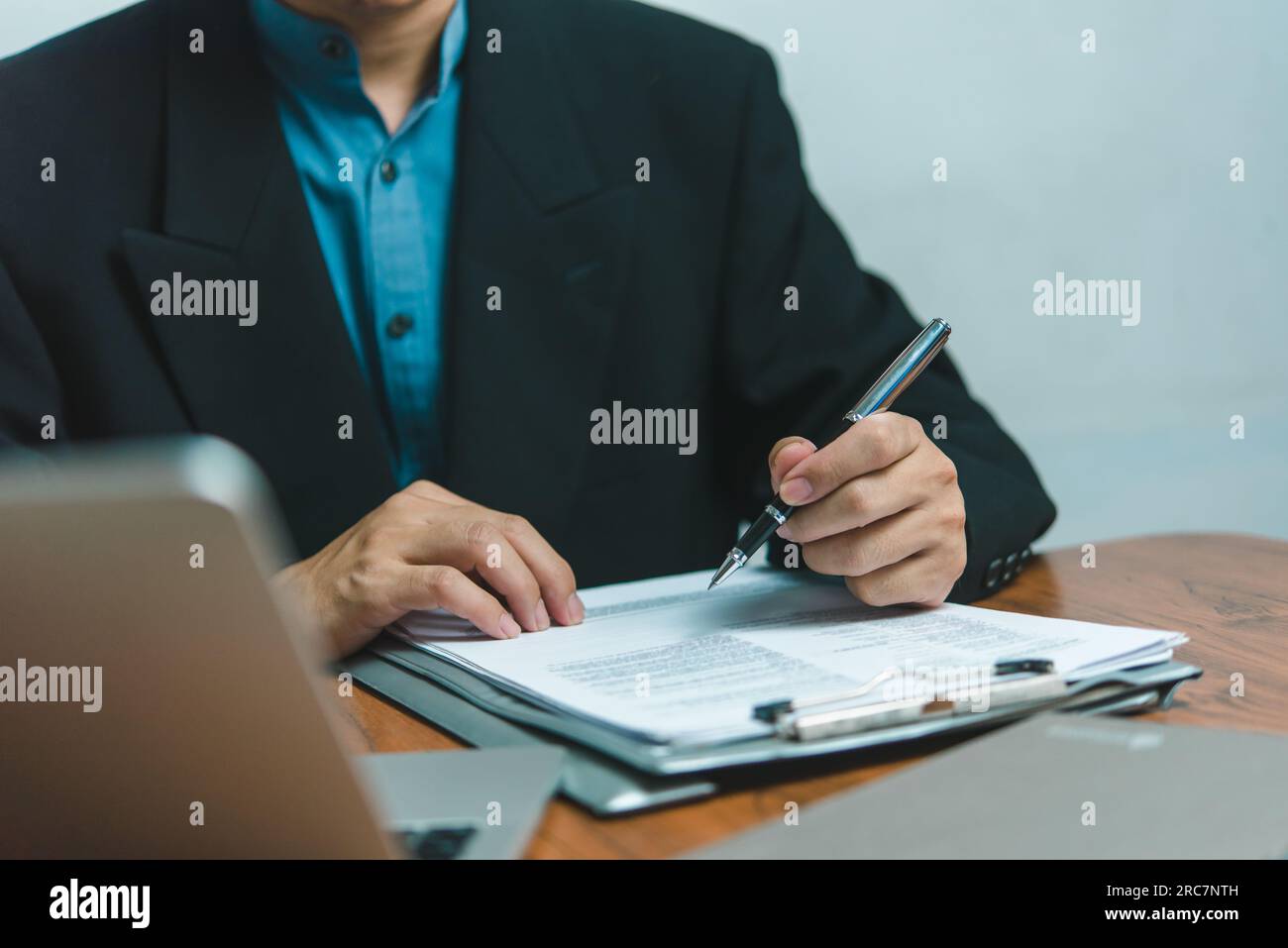 businessman agree to make deal signing document, sale contract, employment job or legal transaction contract at desk Stock Photo
