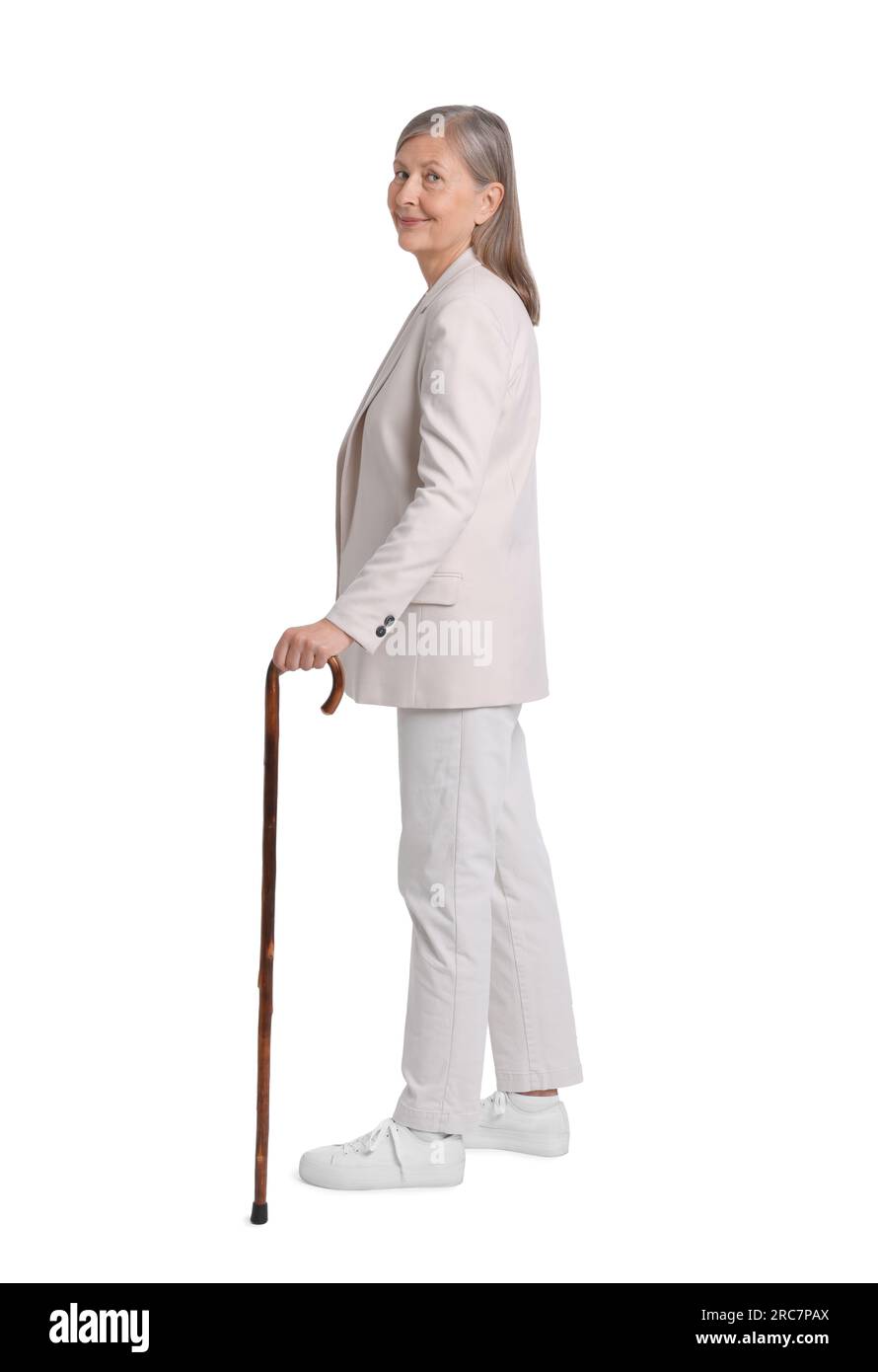 Senior woman with walking cane on white background Stock Photo - Alamy