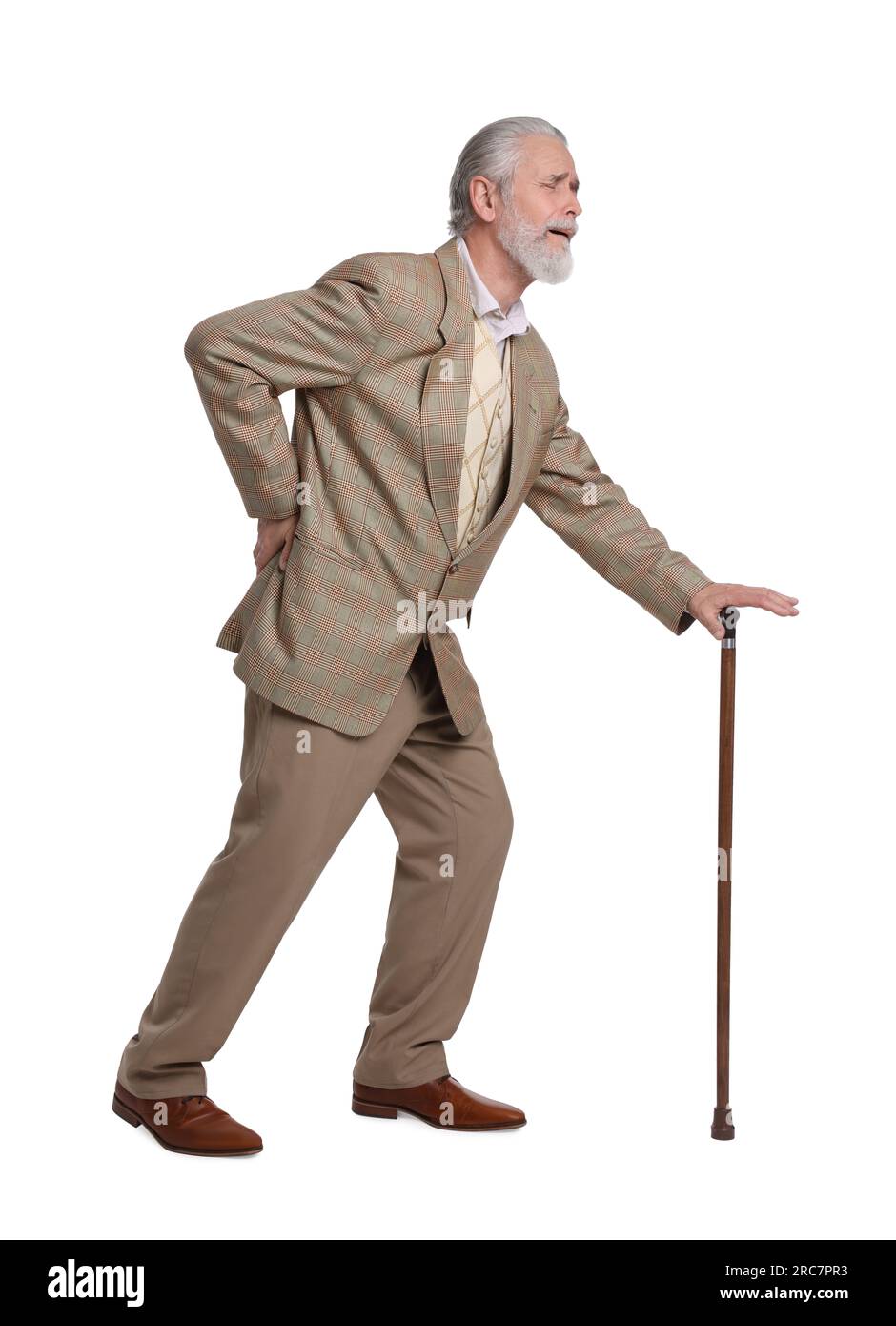 Senior man with walking cane suffering from back pain on white