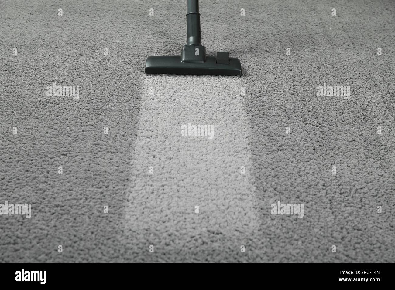 Vacuuming grey carpet. Clean area after using device. Space for text Stock Photo